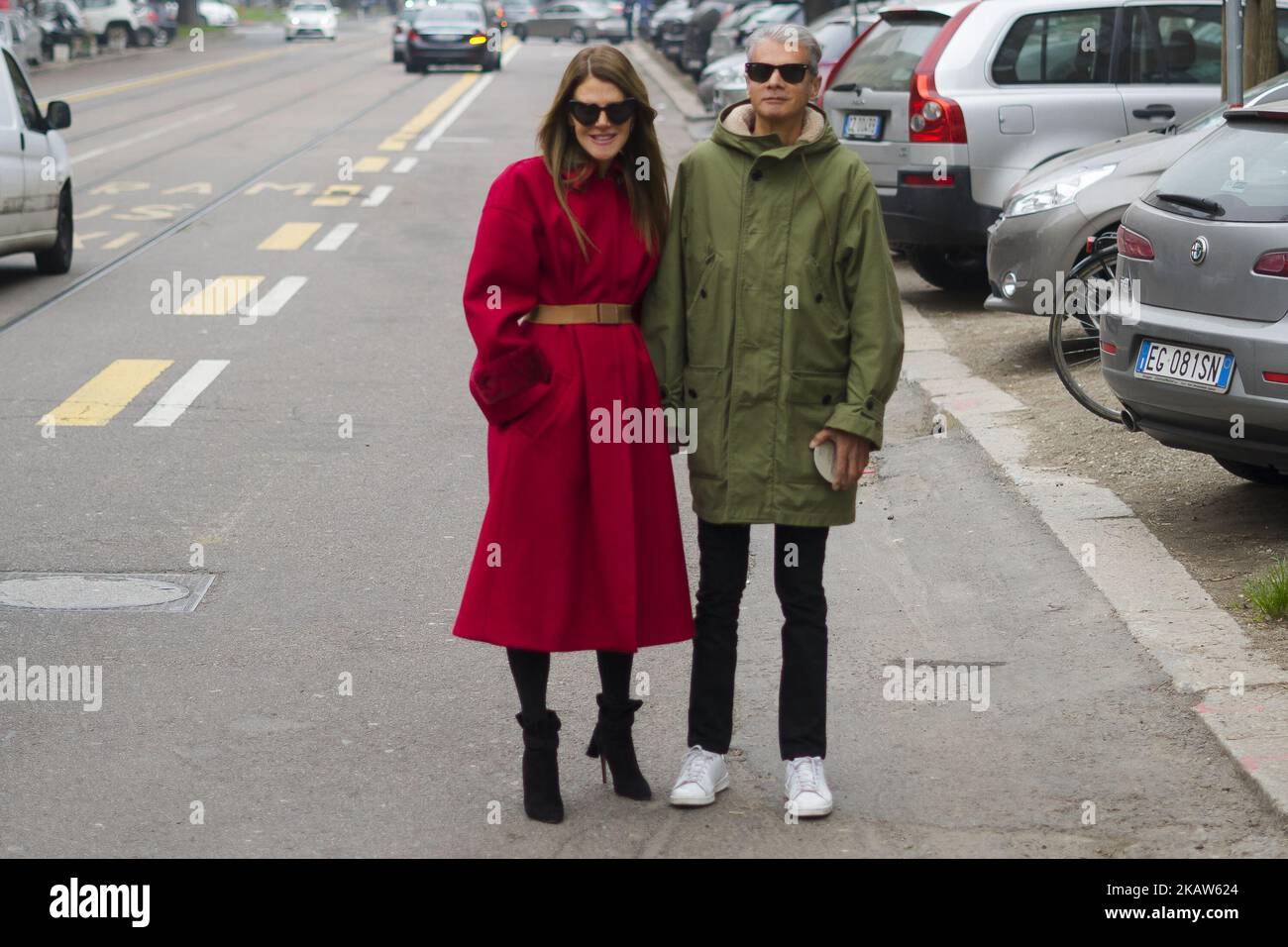 Couple Anna dello Russo wearing red coat with brown belt, black ankle boots and Angelo Gioia is seen outside Fendi during Milan Men's Fashion Week Fall/Winter 2018/19 on January 15, 2018 in Milan, Italy. (Photo by Nataliya Petrova/NurPhoto) Stock Photo