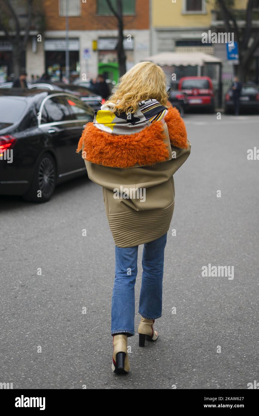 Elina Halimi wearing white knit, cropped denim jeans, ankle boots, beige orange jacket, bag is seen outside No21 during Milan Men's Fashion Week Fall/Winter 2018/19 on January 15, 2018 in Milan, Italy. (Photo by Nataliya Petrova/NurPhoto) Stock Photo