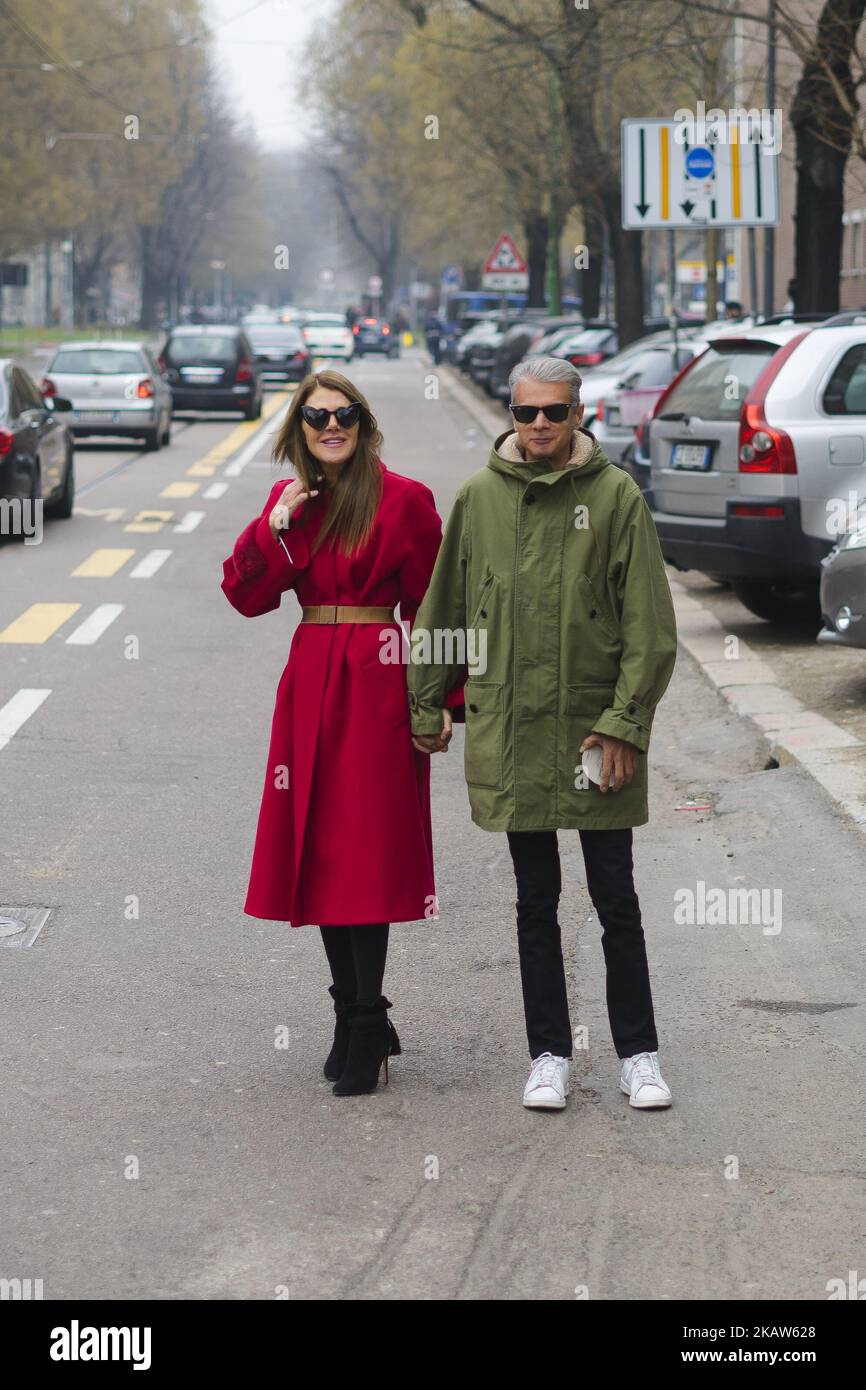 Couple Anna dello Russo wearing red coat with brown belt, black ankle boots and Angelo Gioia is seen outside Fendi during Milan Men's Fashion Week Fall/Winter 2018/19 on January 15, 2018 in Milan, Italy. (Photo by Nataliya Petrova/NurPhoto) Stock Photo
