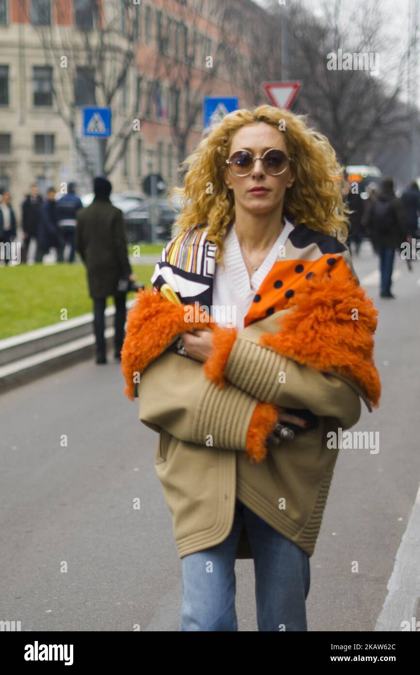 Elina Halimi wearing white knit, cropped denim jeans, ankle boots, beige orange jacket, bag is seen outside No21 during Milan Men's Fashion Week Fall/Winter 2018/19 on January 15, 2018 in Milan, Italy. (Photo by Nataliya Petrova/NurPhoto) Stock Photo