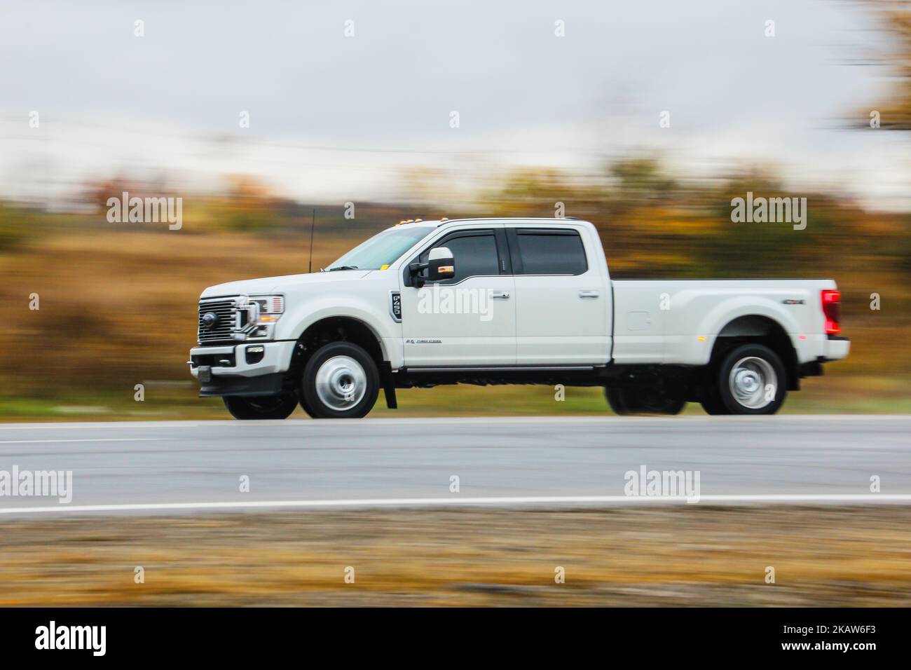 A white Ford Truck on a road against blur background Stock Photo