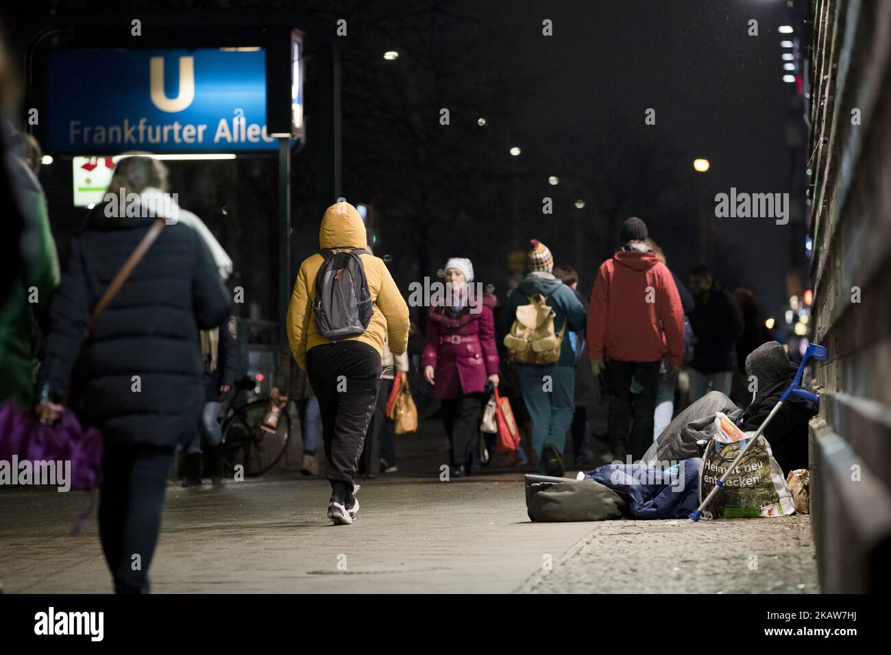 People walk past a homeless person in the Frankfurter Allee in Berlin, Germany on January 19, 2018. (Photo by Emmanuele Contini/NurPhoto) Stock Photo