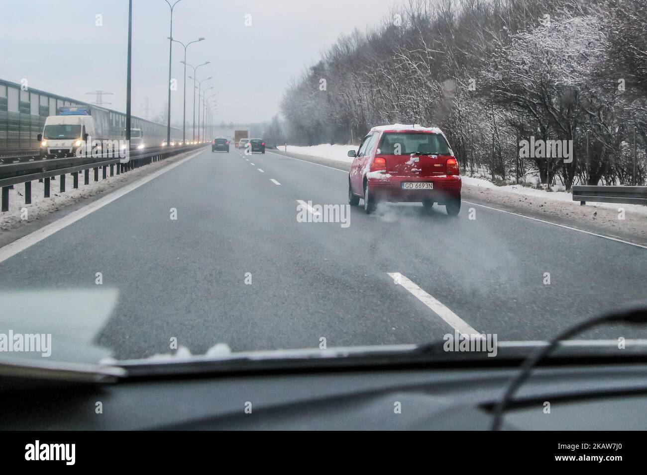Red Volkswagen Lupo covered by the snow at the Tricity ringroad is seen in Gdansk, Poland on 19 January 2018 Heavy snow fall and wind Power has been cut to some 30,000 Polish homes after fierce winds tore across Poland on Thursday night and Friday morning, the Government Security Centre (RCB) has said (Photo by Michal Fludra/NurPhoto) Stock Photo