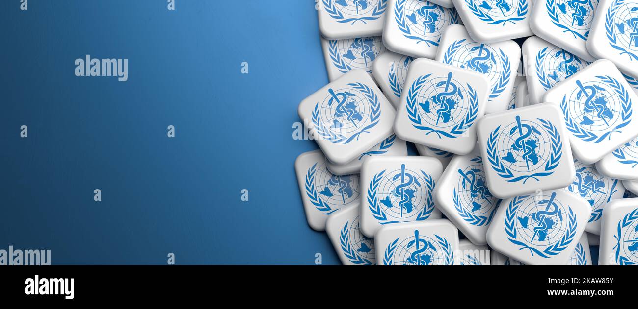 Logos of World Health Organisation on a heap on a table. Web banner format with copy space. Stock Photo