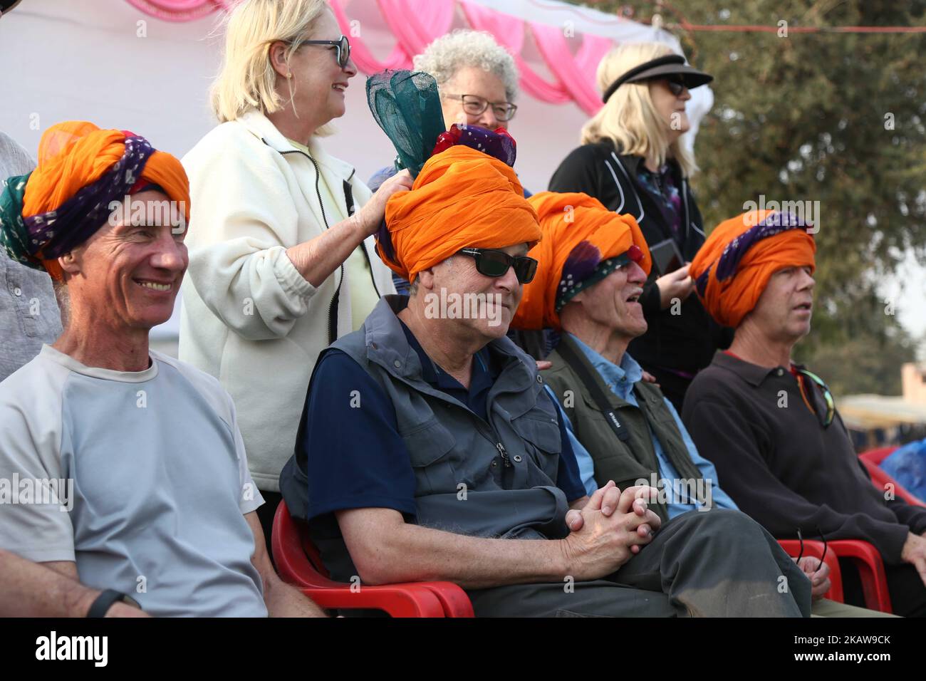 Foreign tourists take part in a turban tying competition at the Nagaur cattle fair, in Nagaur, India on 23 January 2018. (Photo by STR/NurPhoto) Stock Photo