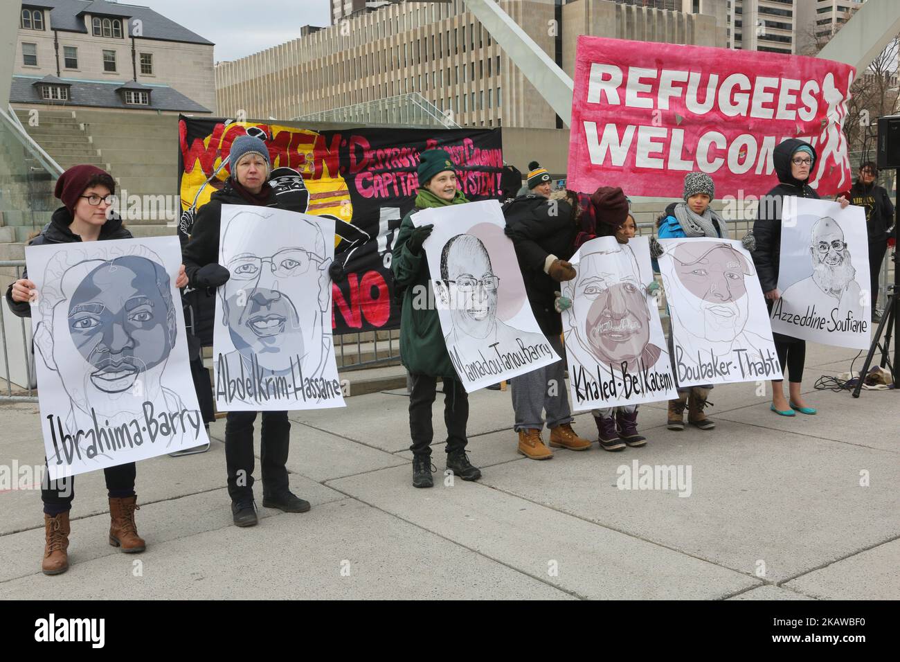 People hold portraits with the names of those killed in the Quebec City mosque shooting that took place one year ago during a rally held in Toronto, Ontario, Canada, on January 27, 2018. The rally was held to remember those killed in the Quebec City mosque and to condemn Islamophobia, hate, and racism. The rally marked one year since the horrific killing of 6 Muslims at the Islamic Cultural Centre of Quebec. Over the past year, there has been a significant rise of Islamophobia and hate across North America and Europe following the election of Donald Trump and the support of far-right politicia Stock Photo