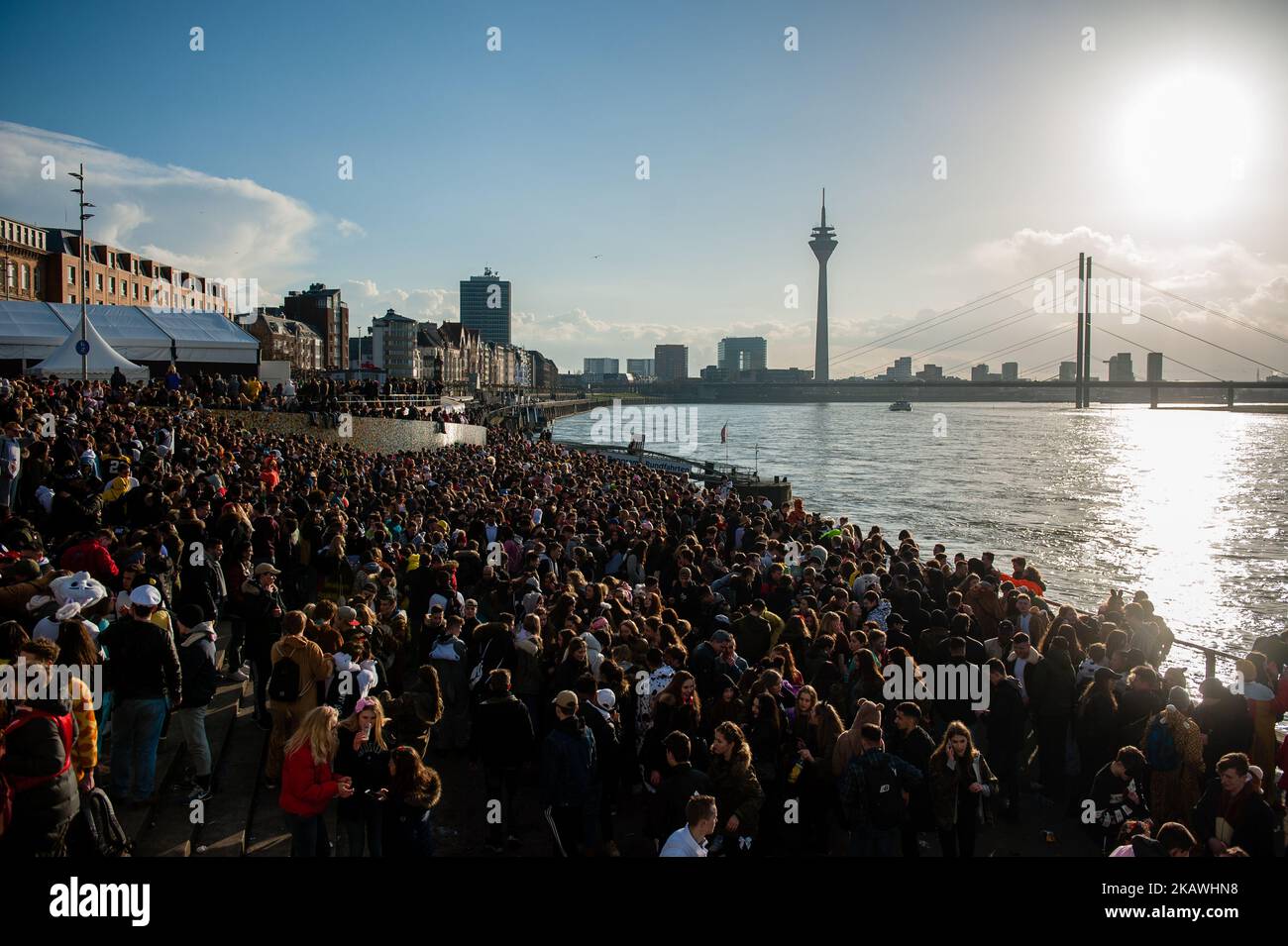 During the afternoon, hundreds of young people gather around the Rhine river, to celebrate Carnaval after the Rose Monday Parade in Dusseldorf, Germany, on February 12th,2018. (Photo by Romy Arroyo Fernandez/NurPhoto) Stock Photo