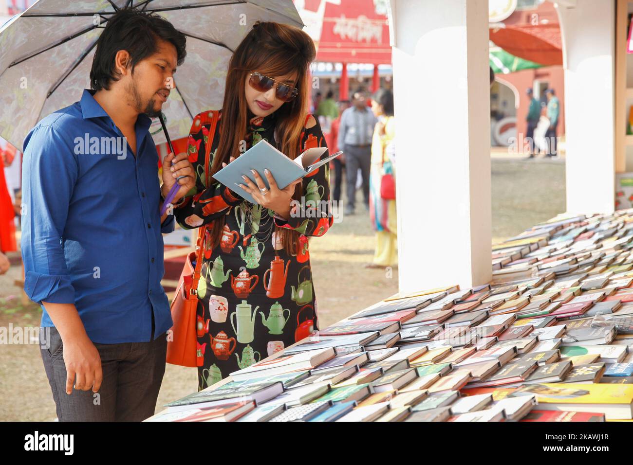 Bangladeshi couple in book fair to celebrate valentine’s day in Dhaka on February 14, 2018. Valentine's Day, also called Saint Valentine's Day or the Feast of Saint Valentine, is celebrated annually on February 14. Originating as a Western Christian feast day honoring one or two early saints named Valentinus, Valentine's Day is recognized as a significant cultural, religious, and commercial celebration of romance and romantic love in many regions around the world, although it is not a public holiday in any country. (Photo by Mehedi Hasan/NurPhoto) Stock Photo