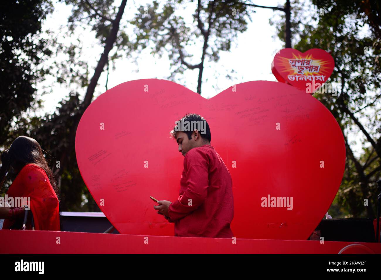 Bangladeshi couple in a park to celebrate valentine’s day in Dhaka on February 14, 2018. Valentine's Day, also called Saint Valentine's Day or the Feast of Saint Valentine, is celebrated annually on February 14. Originating as a Western Christian feast day honoring one or two early saints named Valentinus, Valentine's Day is recognized as a significant cultural, religious, and commercial celebration of romance and romantic love in many regions around the world, although it is not a public holiday in any country. (Photo by Mehedi Hasan/NurPhoto) Stock Photo