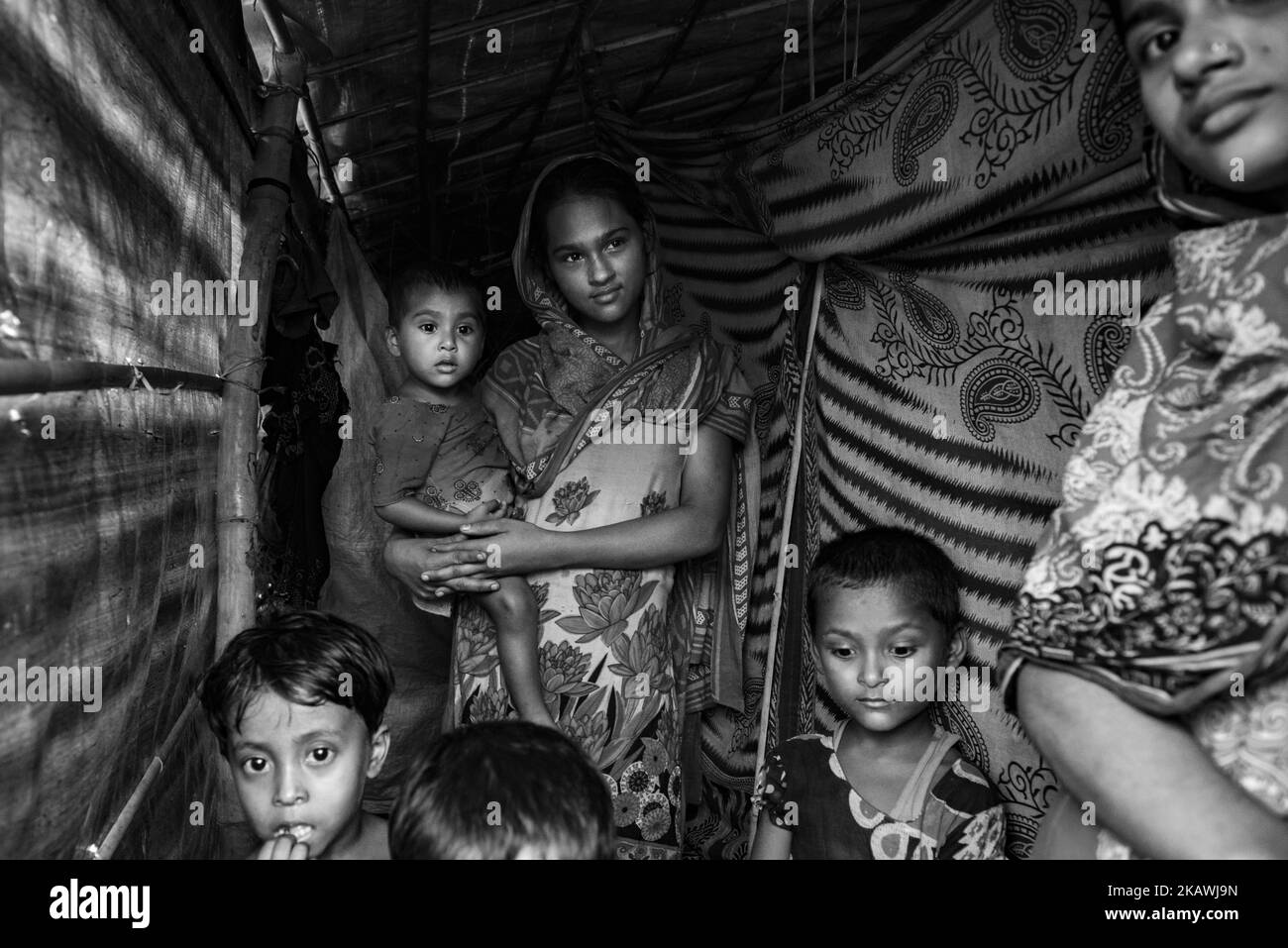 A Rohingya refugee family in a makeshift shelter at the Kutupalong refugee camp near Cox's Bazar, Bangladesh, November 22, 2017. (Photo by Szymon Barylski/NurPhoto) Stock Photo