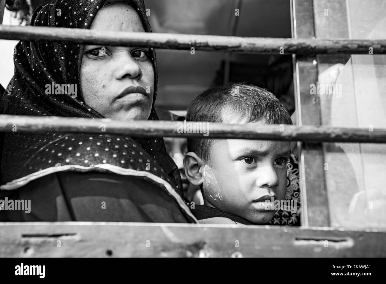 The Rohingya refugee woman with her son inside the bus that will take them to the refugees camp after register at a Border Guard Bangladesh Registration Centre for new arrivals at the Jamtoli refugee camp near Cox's Bazar, Bangladesh, November 22, 2017 (Photo by Szymon Barylski/NurPhoto) Stock Photo
