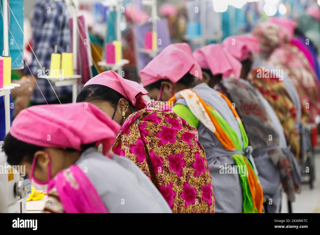 Bangladeshi female workers work at a garments factory in Gazipur outskirts of Dhaka on February 17, 2018. The garment sector has provided employment opportunities to women from the rural areas that previously did not have any opportunity to be part of the formal workforce. This has given women the chance to be financially independent and have a voice in the family because now they contribute financially.However, women workers face problems. Most women come from low income families. Low wage of women workers and their compliance have enabled the industry to compete with the world market.The tex Stock Photo