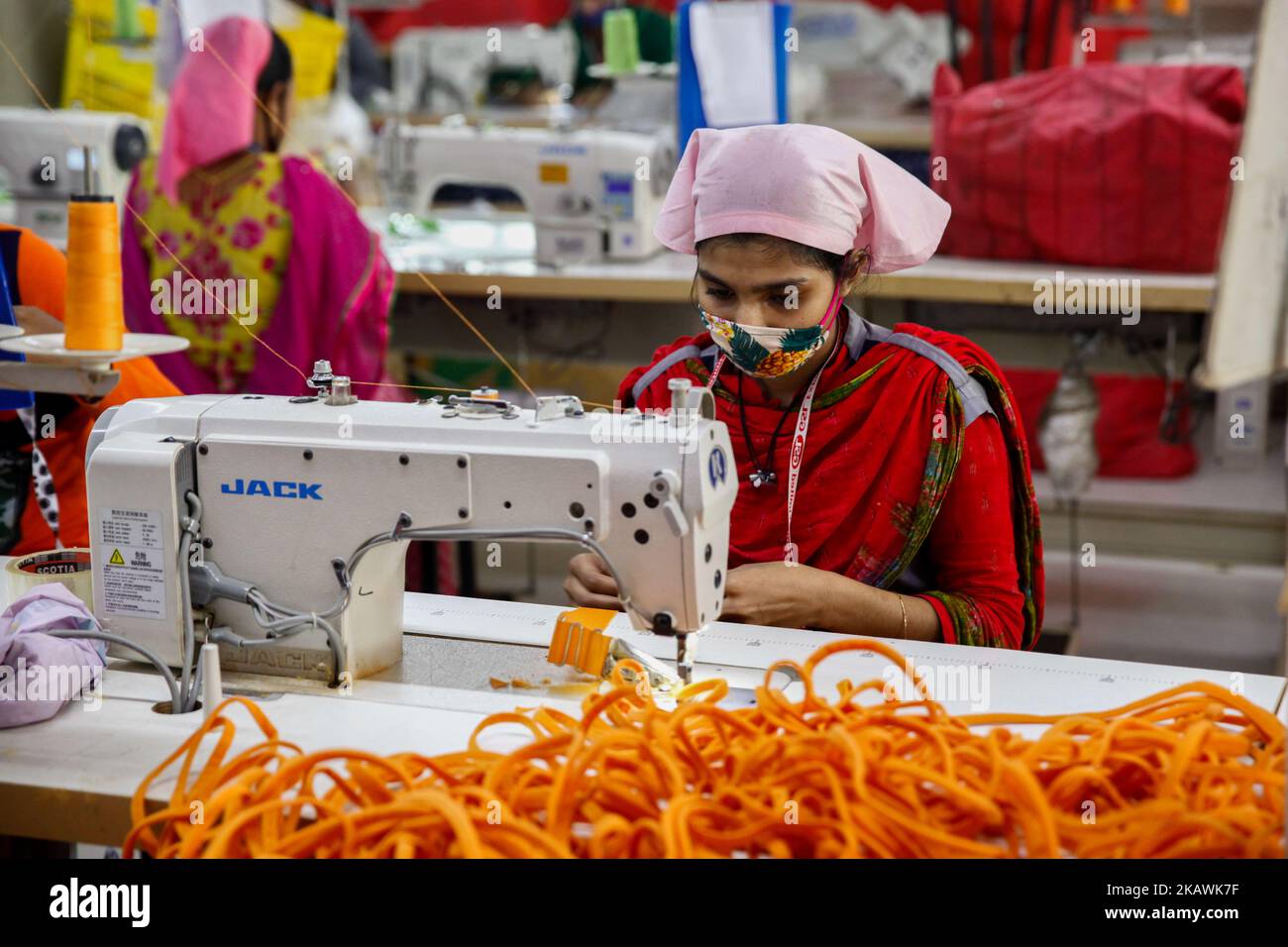 Bangladeshi female workers work at a garments factory in Gazipur outskirts of Dhaka on February 17, 2018. The garment sector has provided employment opportunities to women from the rural areas that previously did not have any opportunity to be part of the formal workforce. This has given women the chance to be financially independent and have a voice in the family because now they contribute financially.However, women workers face problems. Most women come from low income families. Low wage of women workers and their compliance have enabled the industry to compete with the world market.The tex Stock Photo