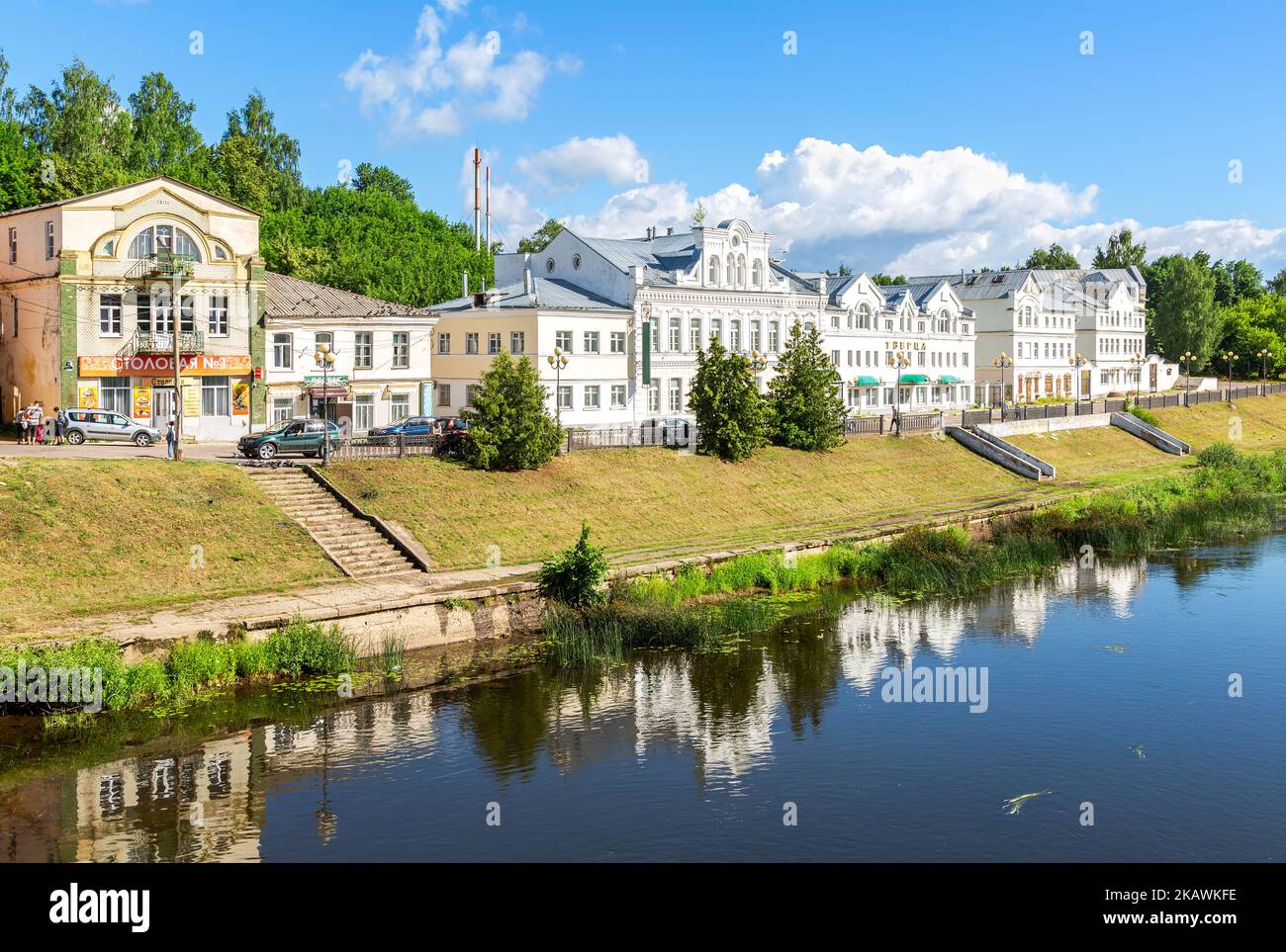 Torzhok, Russia - July 12, 2022: Provincial Russian Torzhok town in summer sunny day. View on old buildings at the embankment from the bridge across t Stock Photo
