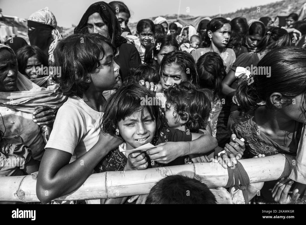 A Rohingya refugee wait to receive food aid from a local NGO at the Balukhali refugee camp near Cox's Bazar, Bangladesh, November 24, 2017. (Photo by Szymon Barylski/NurPhoto) Stock Photo