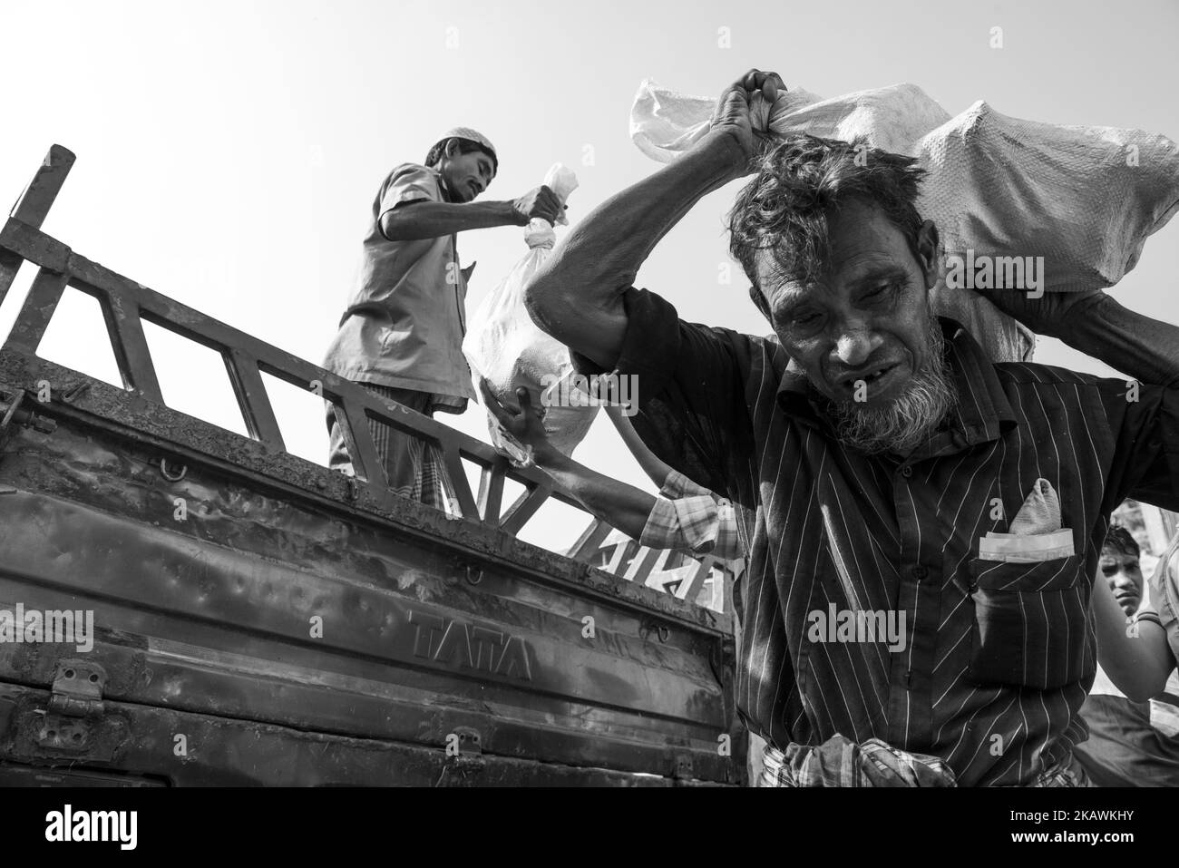 Rohingya refugee man carry relief goods after receiving the supplies at the Balukhali refugee camp near Cox's Bazar, Bangladesh, November 24, 2017. (Photo by Szymon Barylski/NurPhoto) Stock Photo