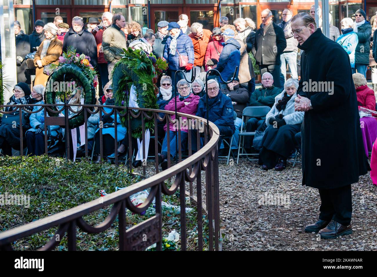 People take part at annual commemoration of the bombing in Nijmegen, Netherlands, on 22 February 2018. he Bombing of Nijmegen was an unplanned bombing attack by American aircraft on the city of Nijmegen in the Netherlands on 22 February 1944. During this Allied mistake bombing, almost 800 people were killed and a large part of the city center of Nijmegen was destroyed. Every February 22nd an official commemoration has take place at the Raadhuishof, the location where the Montessori school was located, where 24 children and 8 sisters were killed. There a monument called 'De Schommel' was erecte Stock Photo