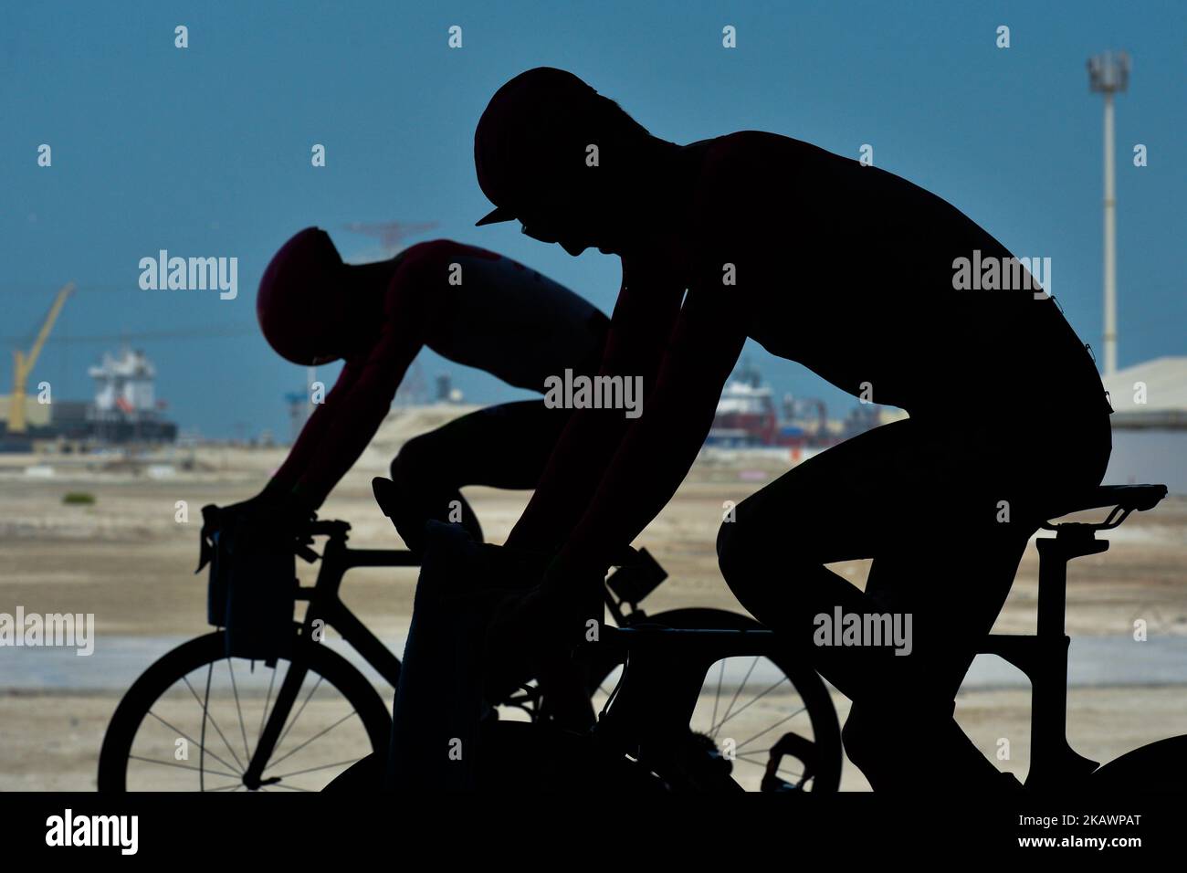 Silhouettes of members of Team EF Education First - Drapac P/B Cannondale preparing for the race ahead of the fourth stage, 12.6km individual time trial Al Maryah Island Stage of the 2018 Abu Dhabi Tour. On Saturday, February 24, 2018, in Al Maryah Island, Abu Dhabi, United Arab Emirates. (Photo by Artur Widak/NurPhoto)  Stock Photo