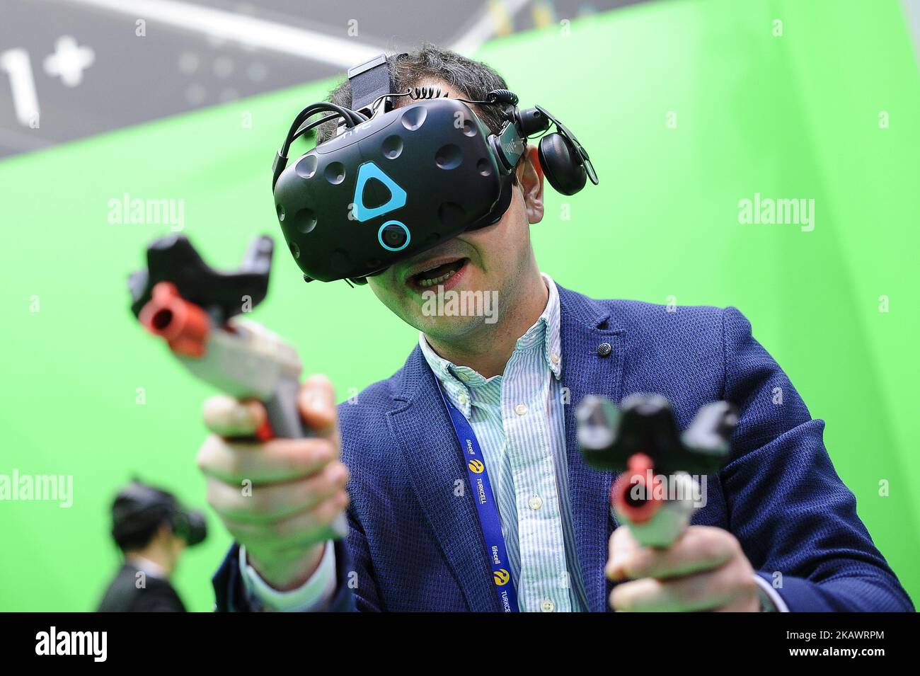 A congress attendant, playing a war game with HTC Vive, at HTC pavilion ...