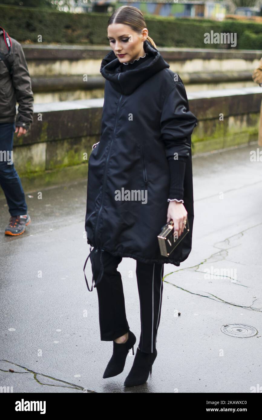 Olivia Palermo wearing black Valentino coat and black pants is