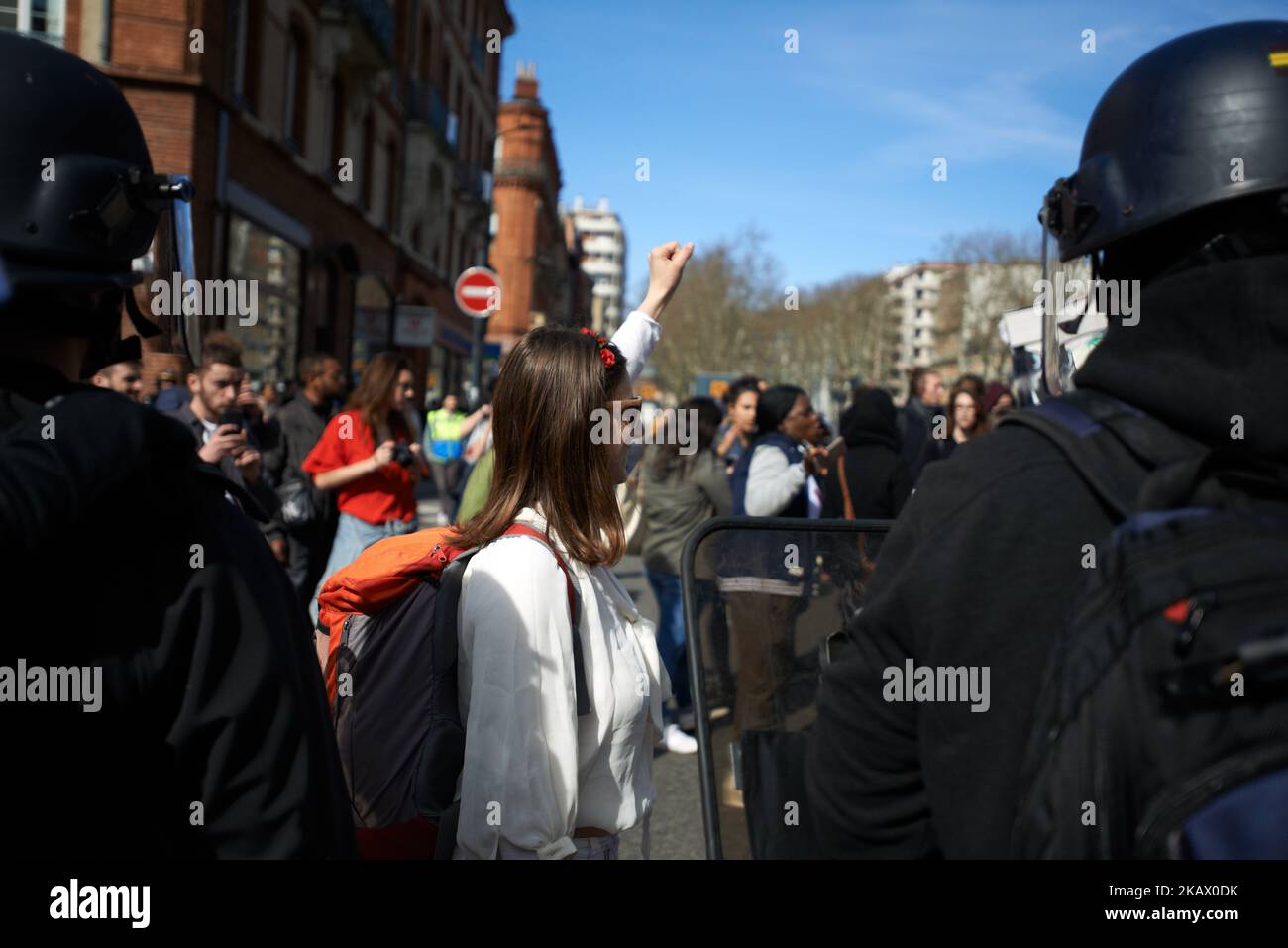 A woman raises her fist as riot police blocks the protest. Women took ...