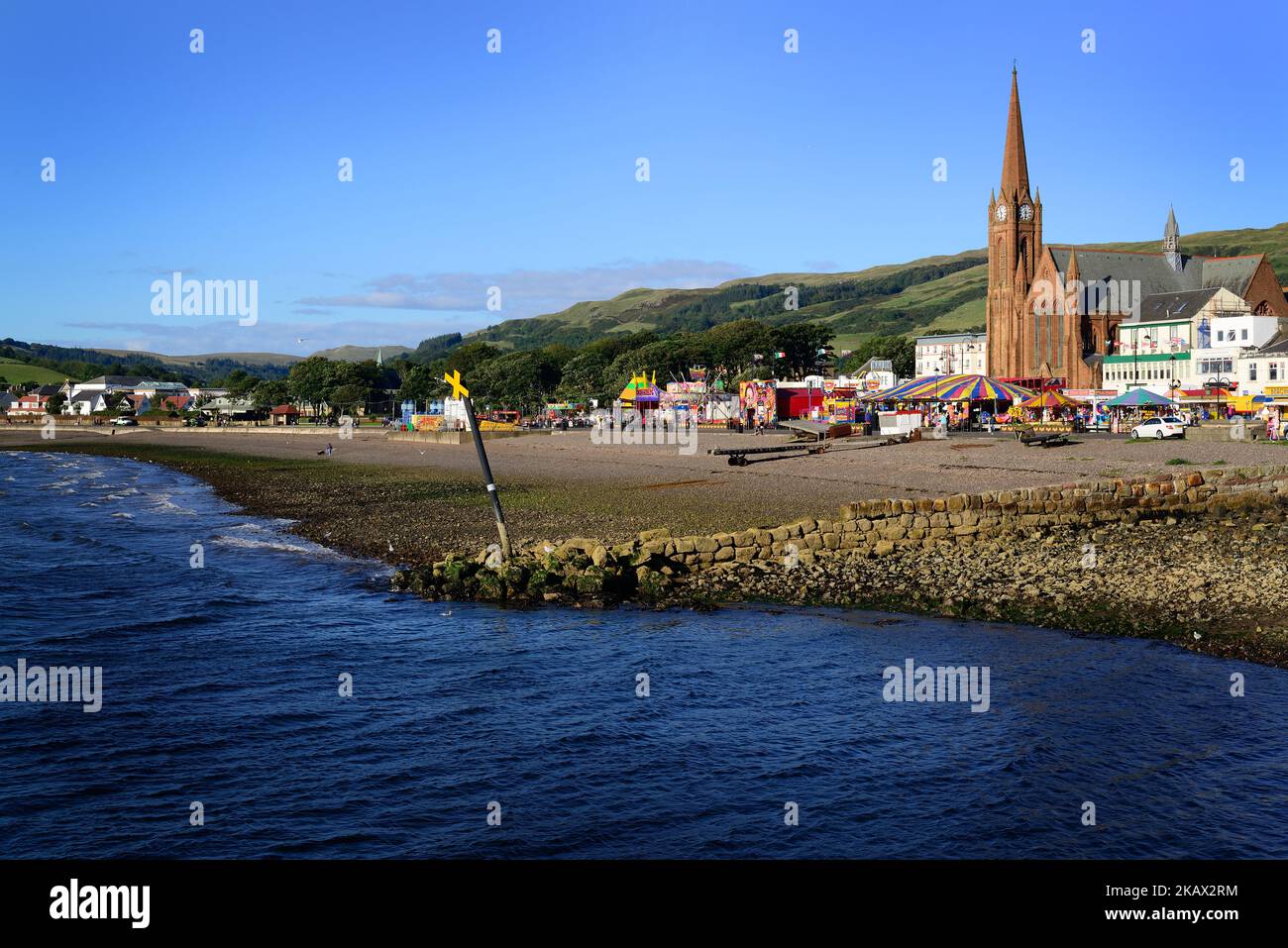 Largs View The view of medieval waterside buildings and hills under the blue sky ...