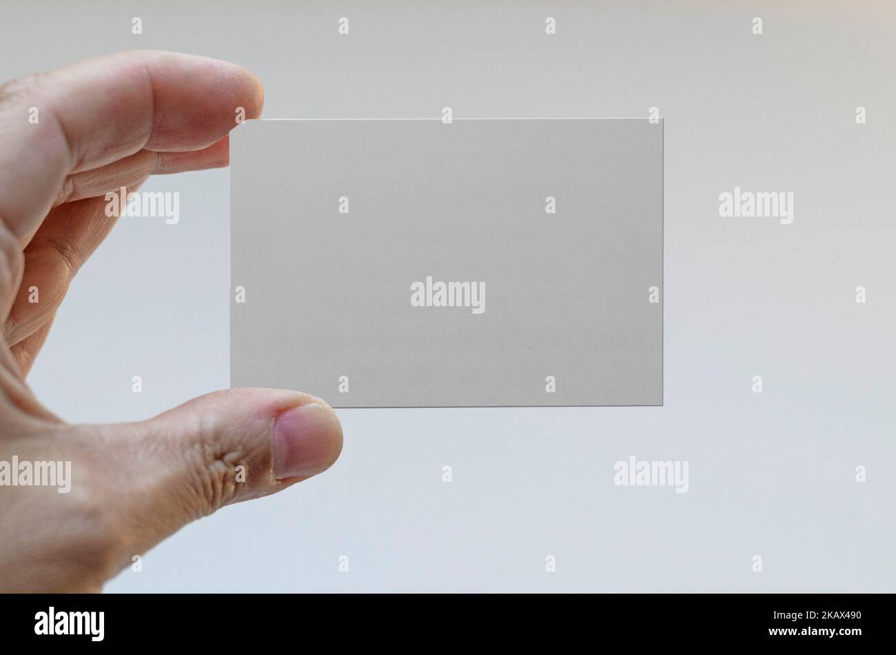 Hand holding a blank business card Stock Photo - Alamy