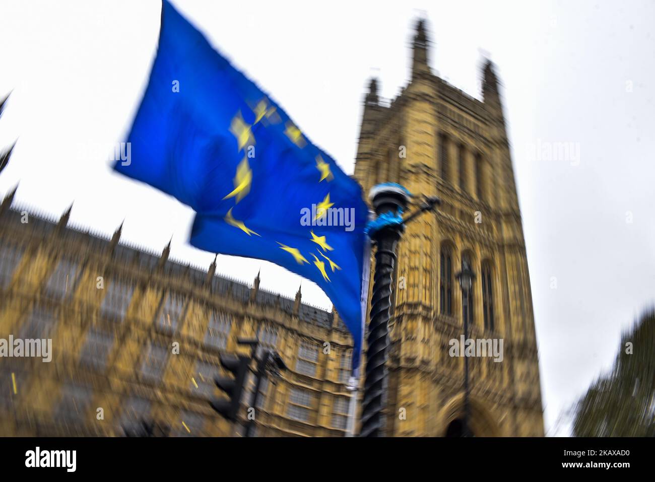 EU and Union Flags are waved opposit to the Houses of Parliament, London on March 27, 2018. Prime Minister Theresa May is facing another Brexit hurdle after the opposition Labour Party announced its pushing for a legal commitment to avoid a hard border with Ireland after Britain leaves the European Union. The Migration Advisory Committee (MAC) said businesses are concerned about their ability to recruit workers from the EU after Britain leaves the EU. UK employers also see EU workers as 'more reliable' and eager than their British counterparts, the report said. (Photo by Alberto Pezzali/NurPho Stock Photo