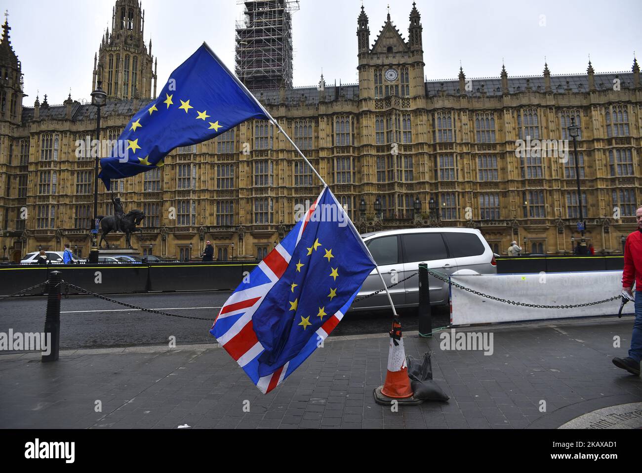 EU and Union Flags are waved opposit to the Houses of Parliament, London on March 27, 2018. Prime Minister Theresa May is facing another Brexit hurdle after the opposition Labour Party announced its pushing for a legal commitment to avoid a hard border with Ireland after Britain leaves the European Union. The Migration Advisory Committee (MAC) said businesses are concerned about their ability to recruit workers from the EU after Britain leaves the EU. UK employers also see EU workers as 'more reliable' and eager than their British counterparts, the report said. (Photo by Alberto Pezzali/NurPho Stock Photo