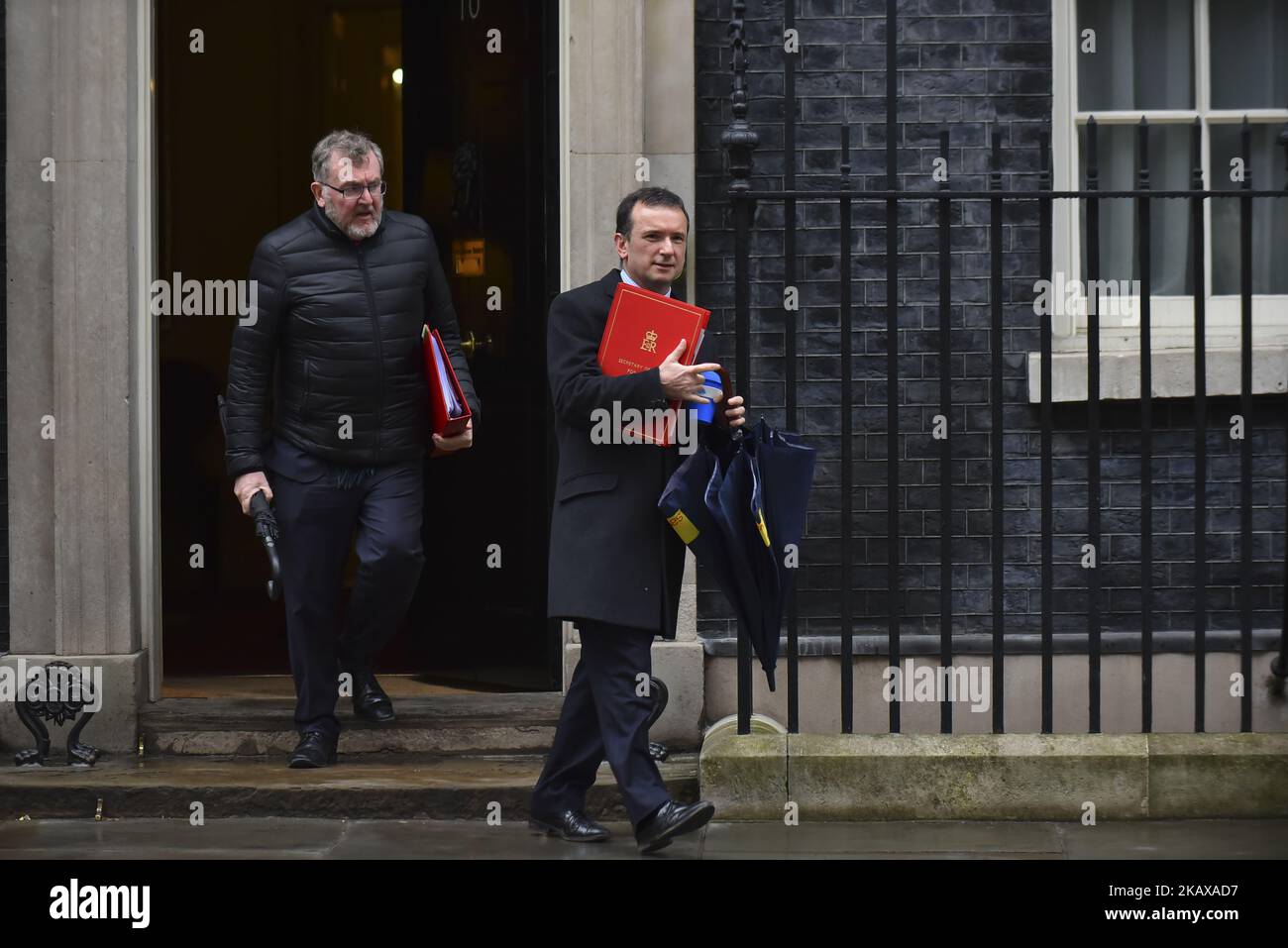 Britain's Secretary of State for Wales Alun Cairns (R) and Secretary of State for Scotland David Mundell leave 10 Downing Street after attending the weekly Cabinet Meeting, London on March 27, 2018. Prime Minister Theresa May is facing another Brexit hurdle after the opposition Labour Party announced its pushing for a legal commitment to avoid a hard border with Ireland after Britain leaves the European Union. The Migration Advisory Committee (MAC) said businesses are concerned about their ability to recruit workers from the EU after Britain leaves the EU. UK employers also see EU workers as ' Stock Photo