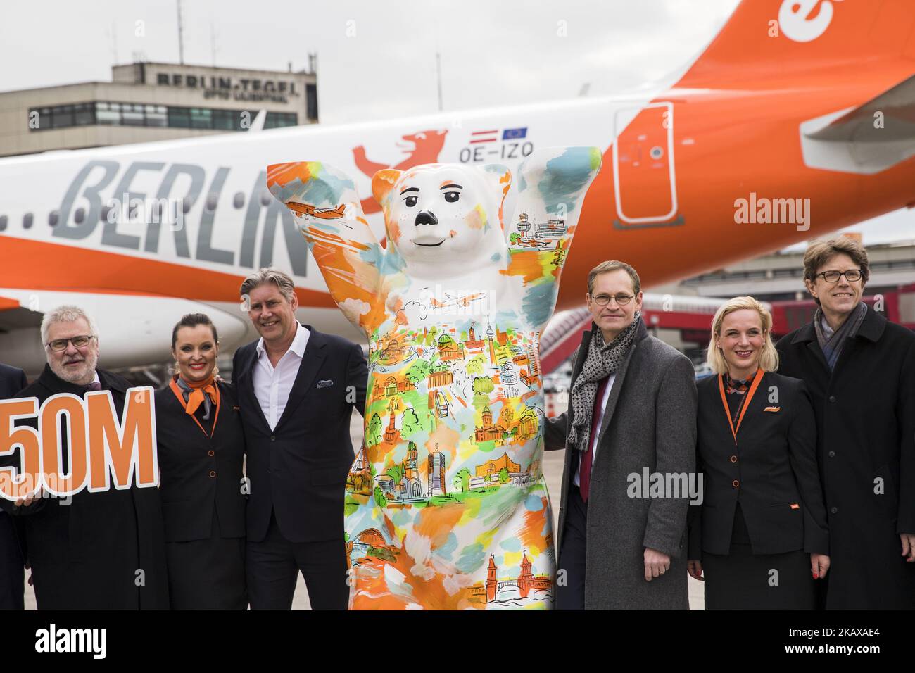 Cabin crew and Brandeburg Sate Secretary and Berlin-Brandenburg Airport Coordinator Rainer Bretschneider (L), Easyjet-CEO Johan Lundgren (3L), Berlin's Mayor Michael Mueller (3R) and Chief of Berlin-Brandenburg Airport society Engelbert Luetke Daldrup pose for a picture in front of an easyJet plane carrying a Berlin design at Tegel airport in Berlin, Germany on March 27, 2018. The airline presented today the summer flight plan. Starting from this summer season the airline will become the biggest actor in Berlin with over 16 millions seats offer per year. (Photo by Emmanuele Contini/NurPhoto) Stock Photo