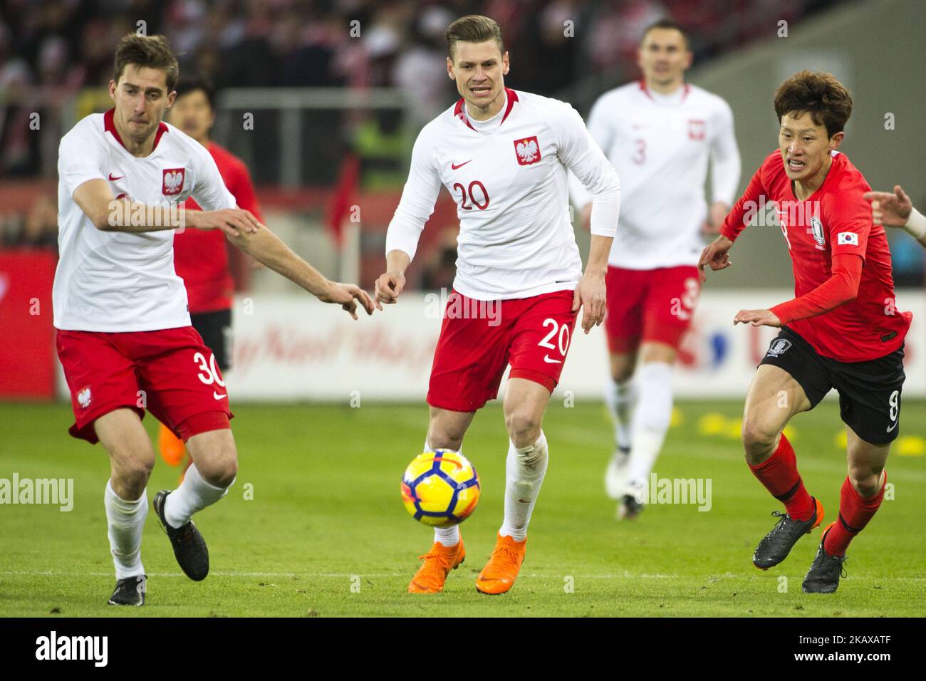 Taras Romanczuk and Lukasz Piszczek of Poland with Jae-sung Lee of Korea during the international friendly match between Poland and South Korea at Silesian Stadium in Chorzow, Poland on March 27, 2018 (Photo by Andrew Surma/NurPhoto) Stock Photo