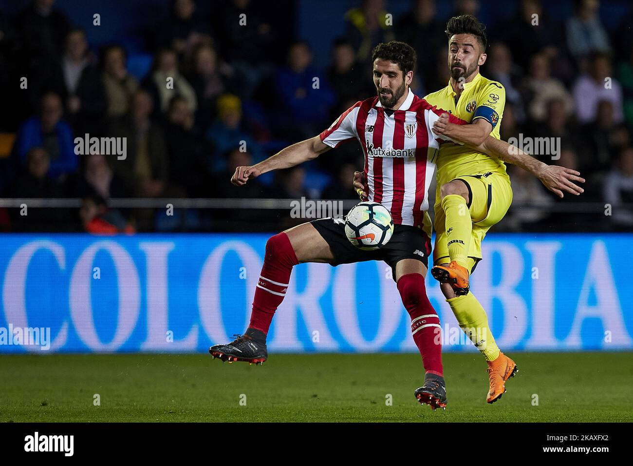 Raul Garcia (L) of Athletic Club de Bilbao competes for the ball with
