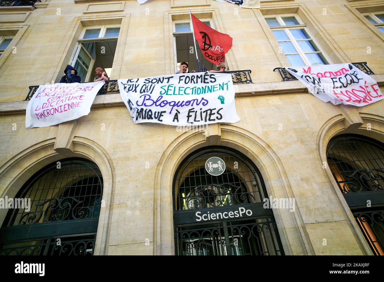 Students block the entrance of Sciences Po university on April 18, 2018 in Paris, as part of nation-wide demonstrations against higher education reforms, introduced by the French government that give public universities the power to set admission criteria and rank applicants. Placards, suspended from balconies of Sciences Po university, read (From L) 'Sciences Po's students against Macron's dictatorship', 'Here are trained those who select. Blocking the elite factory.' 'Macron your school is blocked'. (Photo by Michel Stoupak/NurPhoto) Stock Photo