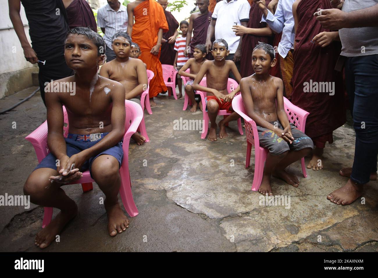 Sri Lankan boys await to get their heads shaved by Sri Lankan Buddhist monks during a ceremony to be ordained as novice Buddhist monks (samanera) in Colombo, Sri Lanka on Sunday 29 April 2018 which also marks the Vesak full moon poya day Celebrated by Buddhists to mark three momentous events in Lord Buddha's life – his birth, enlightenment, and his departure from the human world. (Photo by Tharaka Basnayaka/NurPhoto) Stock Photo