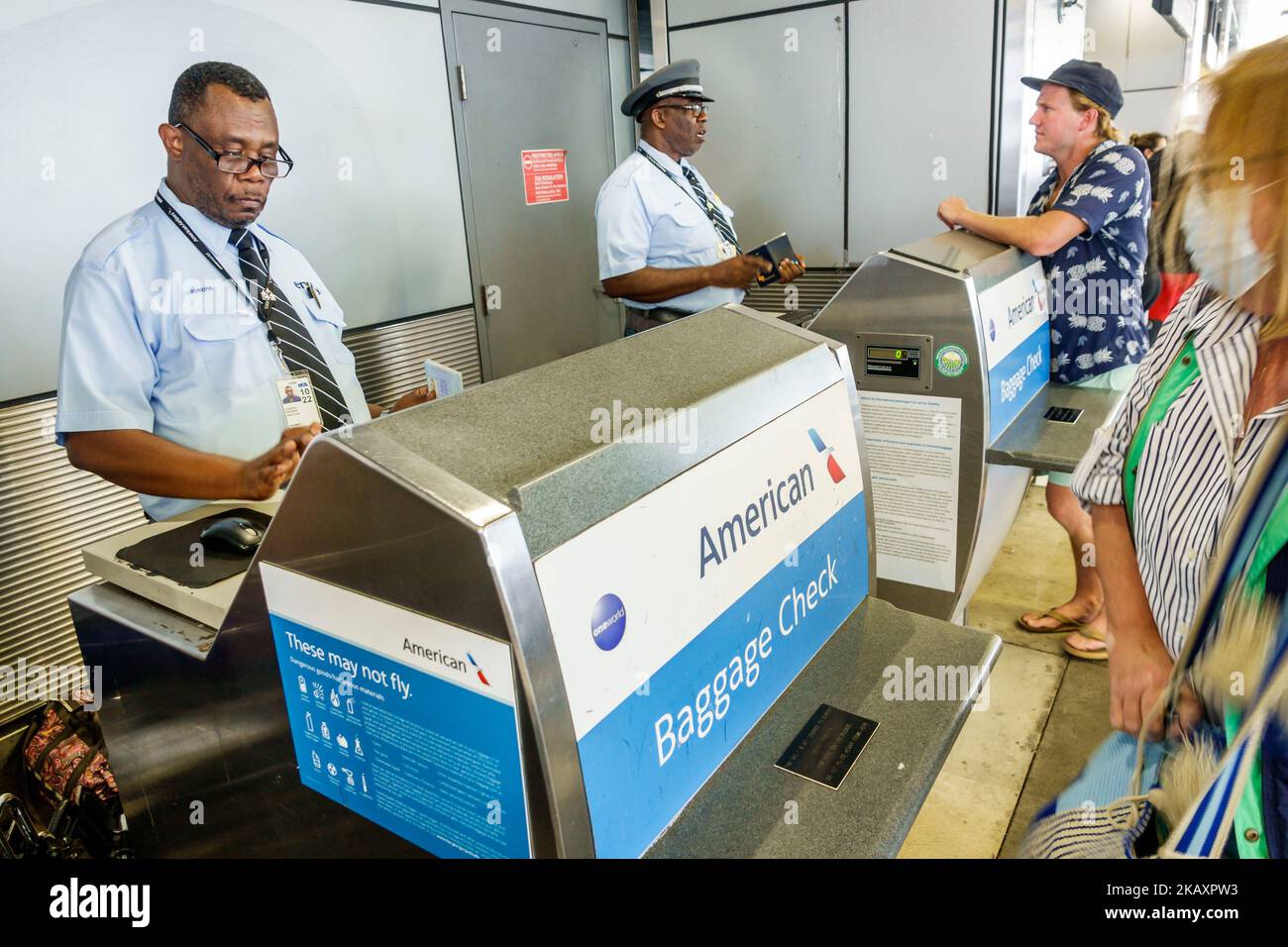 Miami Florida,Miami International Airport MIA terminal,American Airlines Black skycap curbside baggage check,employee employees worker workers working Stock Photo