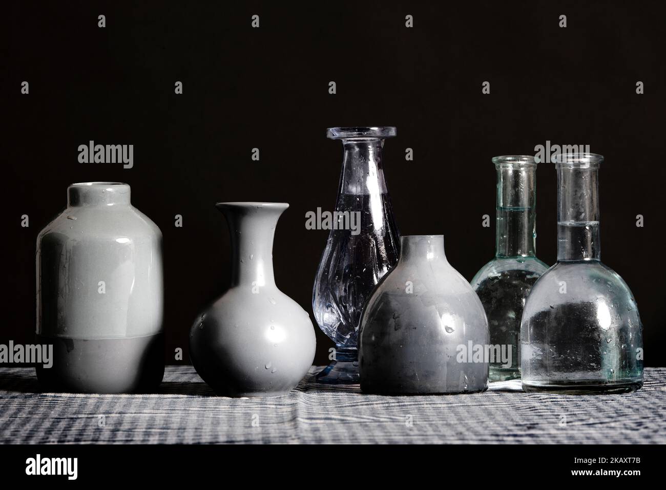 A collection of grey vases placed on a table. Stock Photo