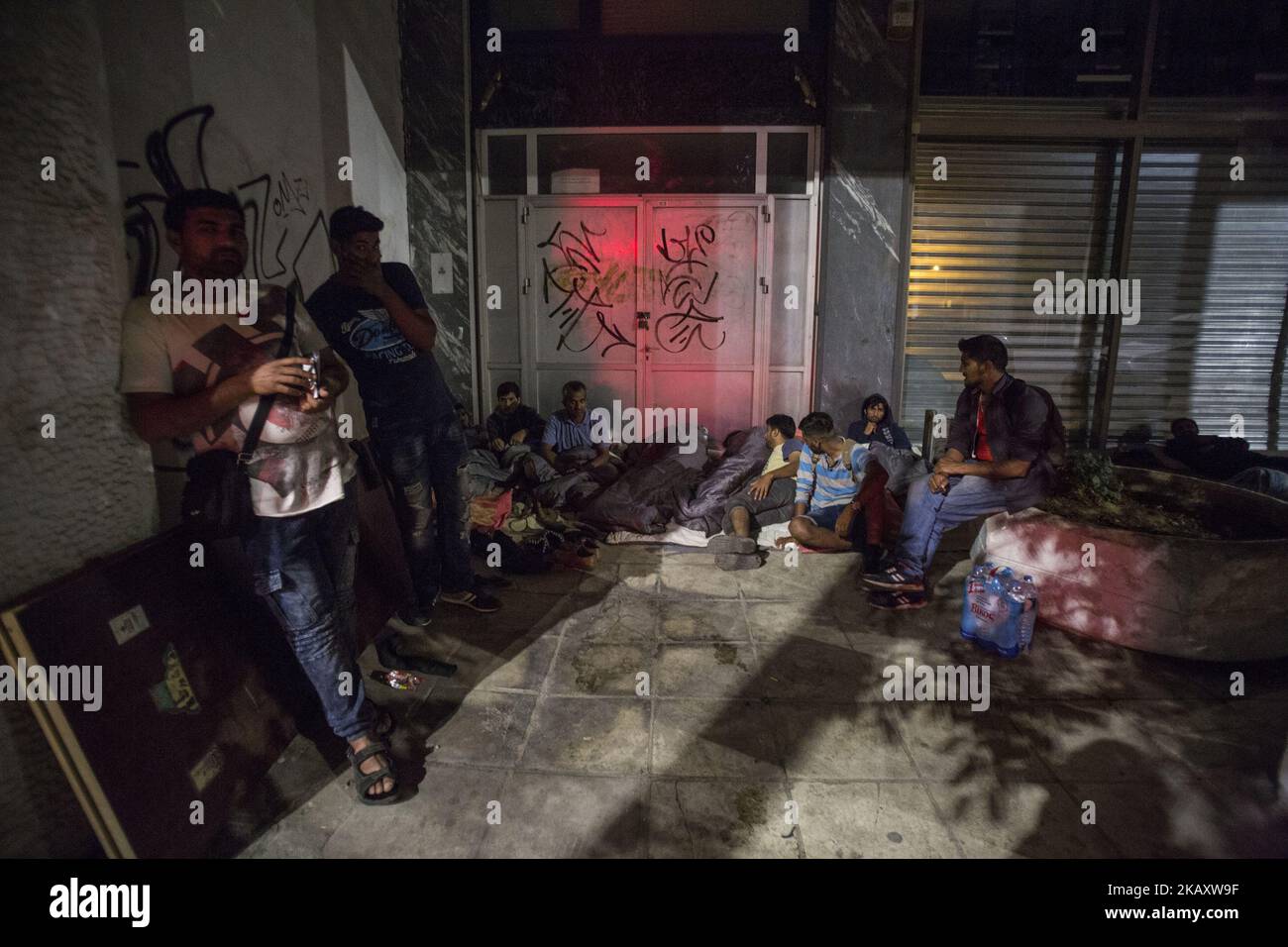 Pakistani migrants spending the night outdoors in Thessaloniki city in Greece. The group of men is denied to stay in any shelter even with the proper documents, so they spend the night and are living outside in the streets. NGOs provide them food but not in the weekends. Some of the people from Pakistan have health issues and are asking for food and to be transferred to Italy or Germany. Pictures are taken after midnight in May 2018. (Photo by Nicolas Economou/NurPhoto) Stock Photo