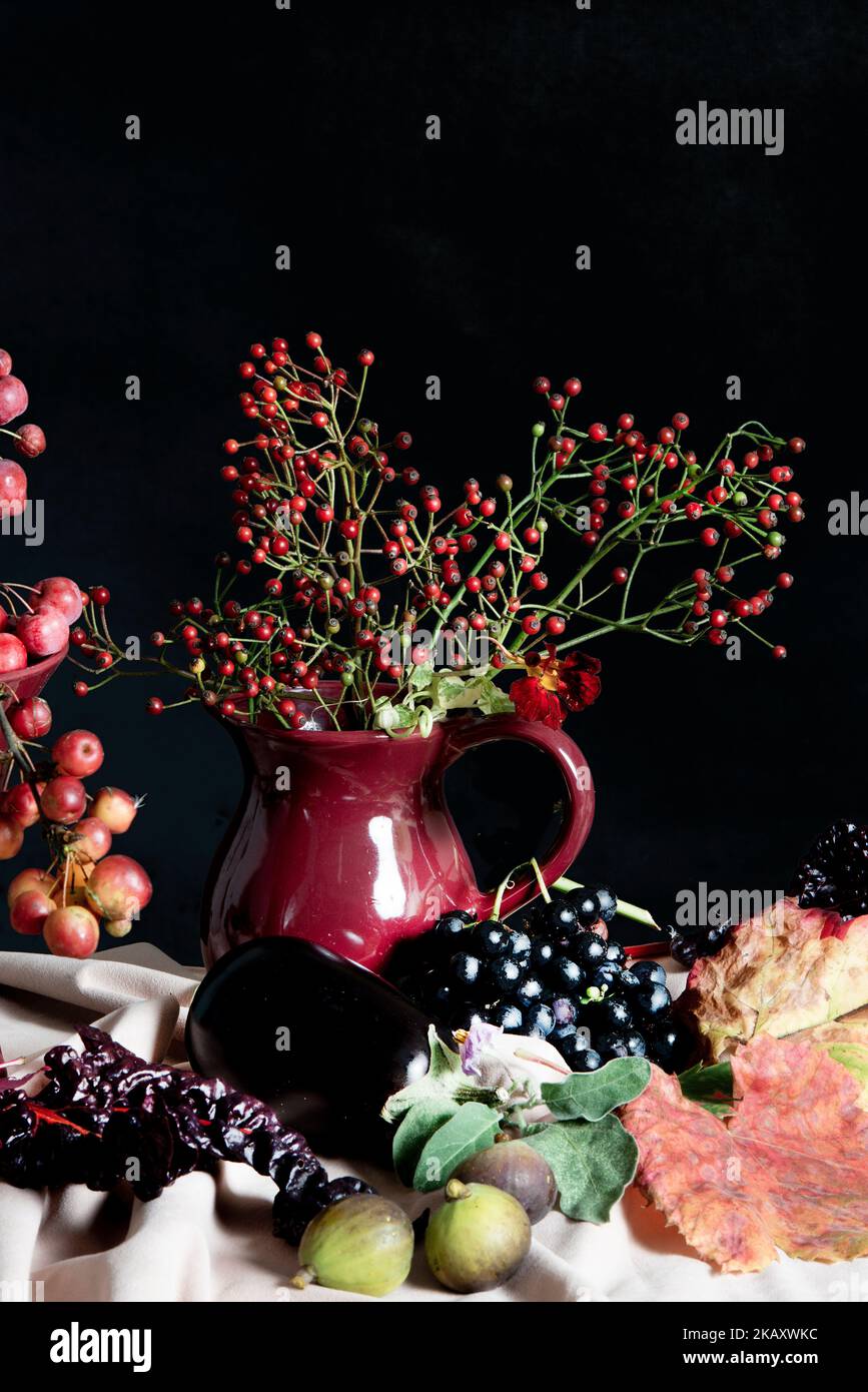 Autumn table setting with twigs of berries in vases. Stock Photo