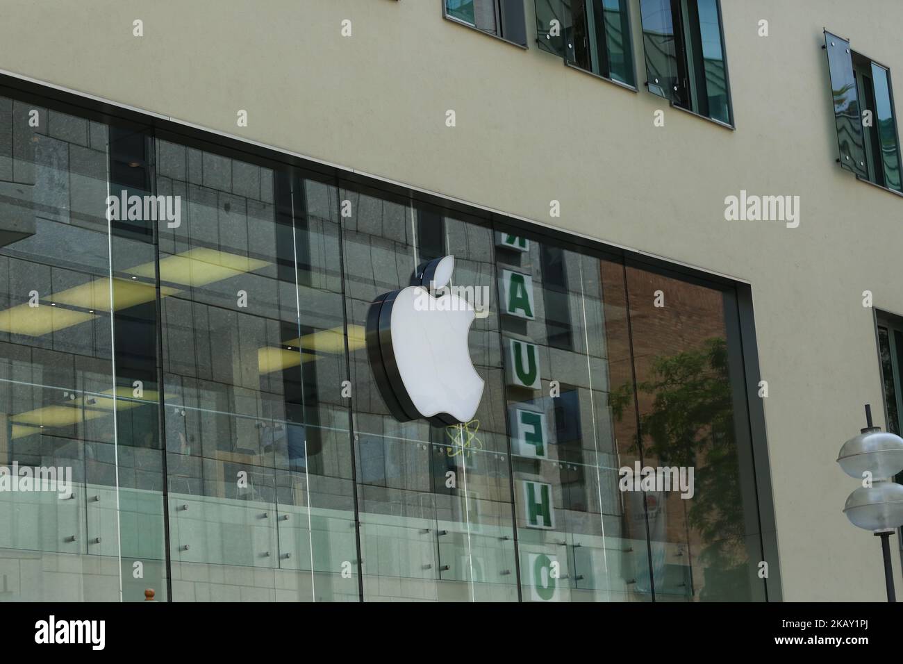 The logo of the American multinational technology company Apple headquartered in Cupertino, California, that designs, develops, and sells consumer electronics, computer software, and online services is seen in the Munich pedestrian zone. (Photo by Alexander Pohl/NurPhoto) Stock Photo