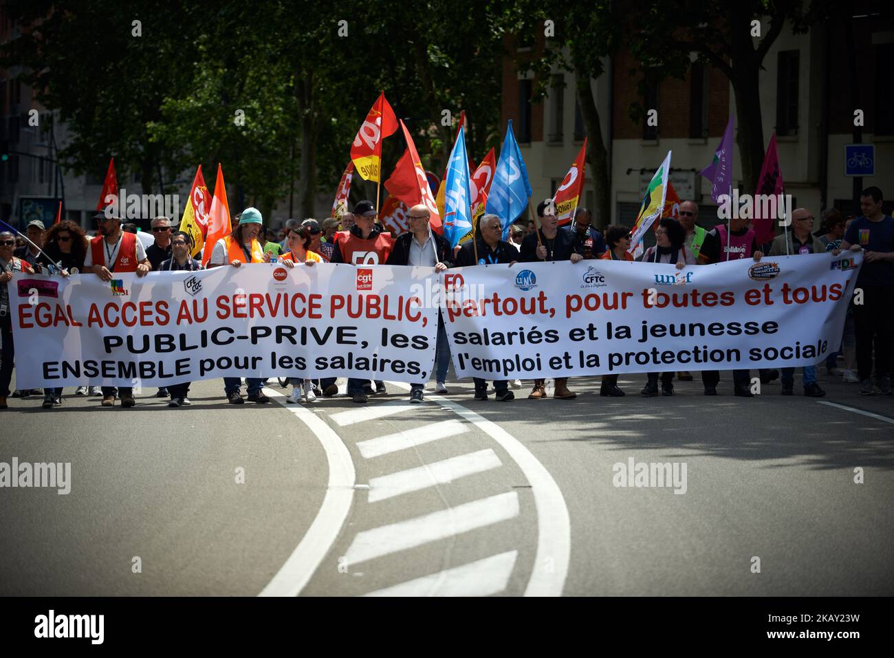 More than 10.000 protestors take to the streets of Toulouse for the 3rd time in a show of defiance towards the Macron's Government and its planned reforms on public services (rail, health, finances, education, etc.). Macron plans to lay off 120.000 civil servants during his presidential mandate. Civils servants, hospital staff and other state employees, teachers demonstrated called by all seven major trade unions (CGT, FO, FSU, CFTC, Solidaires, Unsa et CFE-CGC). Between 130 to 140 demonstrations are planned nationwide. Toulouse. France. May 22th 2018. (Photo by Alain Pitton/NurPhoto) Stock Photo