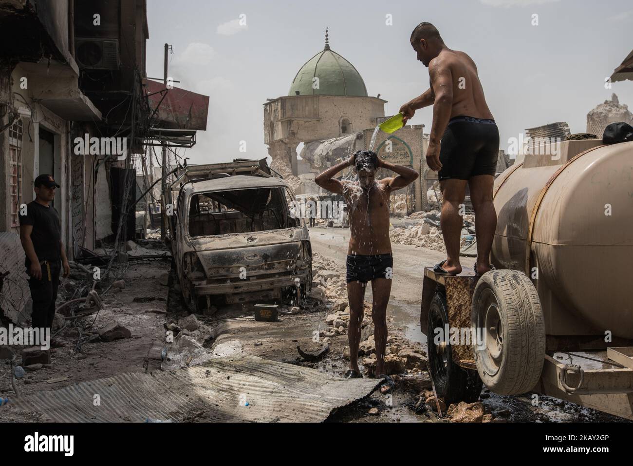 (7/3/2017) Soldiers wash themselves in front of the destroyed Al-Nuri Mosque in the old town of West Mossuls where Al-Baghdadi called the caliphate (Photo by Sebastian Backhaus/NurPhoto) Stock Photo