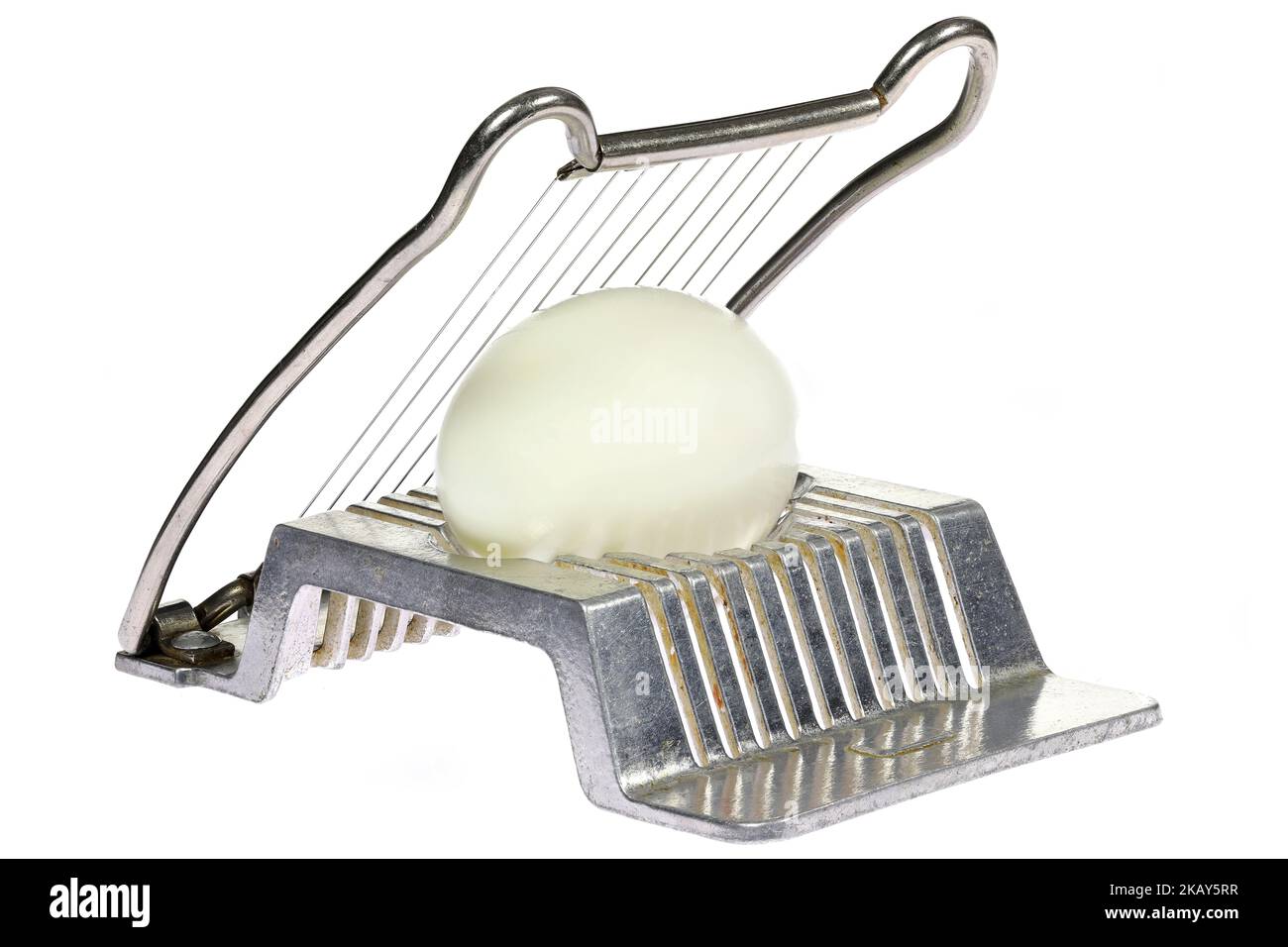 vintage aluminium egg slicer with hardboiled chicken egg isolated on