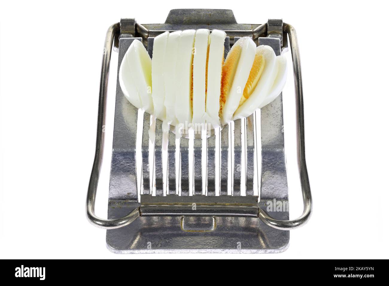 vintage aluminium egg slicer with hardboiled chicken egg isolated on