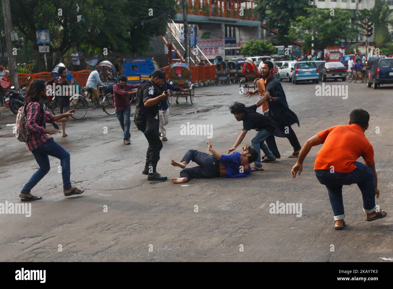 Bangladeshi elite force Rapid Action Battalion or RAB baton charge during the arrest of Ganajagaran Mancha spokesman Imran H Sarker ahead of a planned rally against extrajudicial killings in Bangladesh on June 6, 2018 (Photo by Mehedi Hasan/NurPhoto) Stock Photo