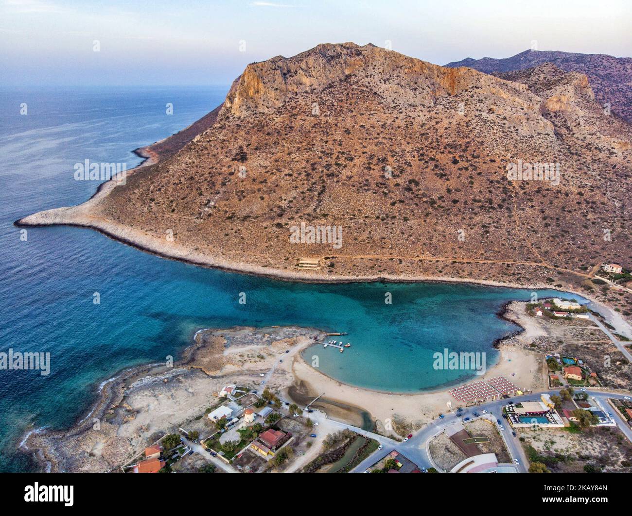 Aerial images of Stavros beach, Crete Island, Greece, on 3 June 2018. The end of the peninsula forming an amazing protected bay with a steep hill in the background, a sandy beach and a little marine for fishing boats. Stavros beach is near Chania city. Stavros Beach was where the Zorba the Greek dance was filmed. It is rugged country ending in a beautiful clear beach. (Photo by Nicolas Economou/NurPhoto) Stock Photo