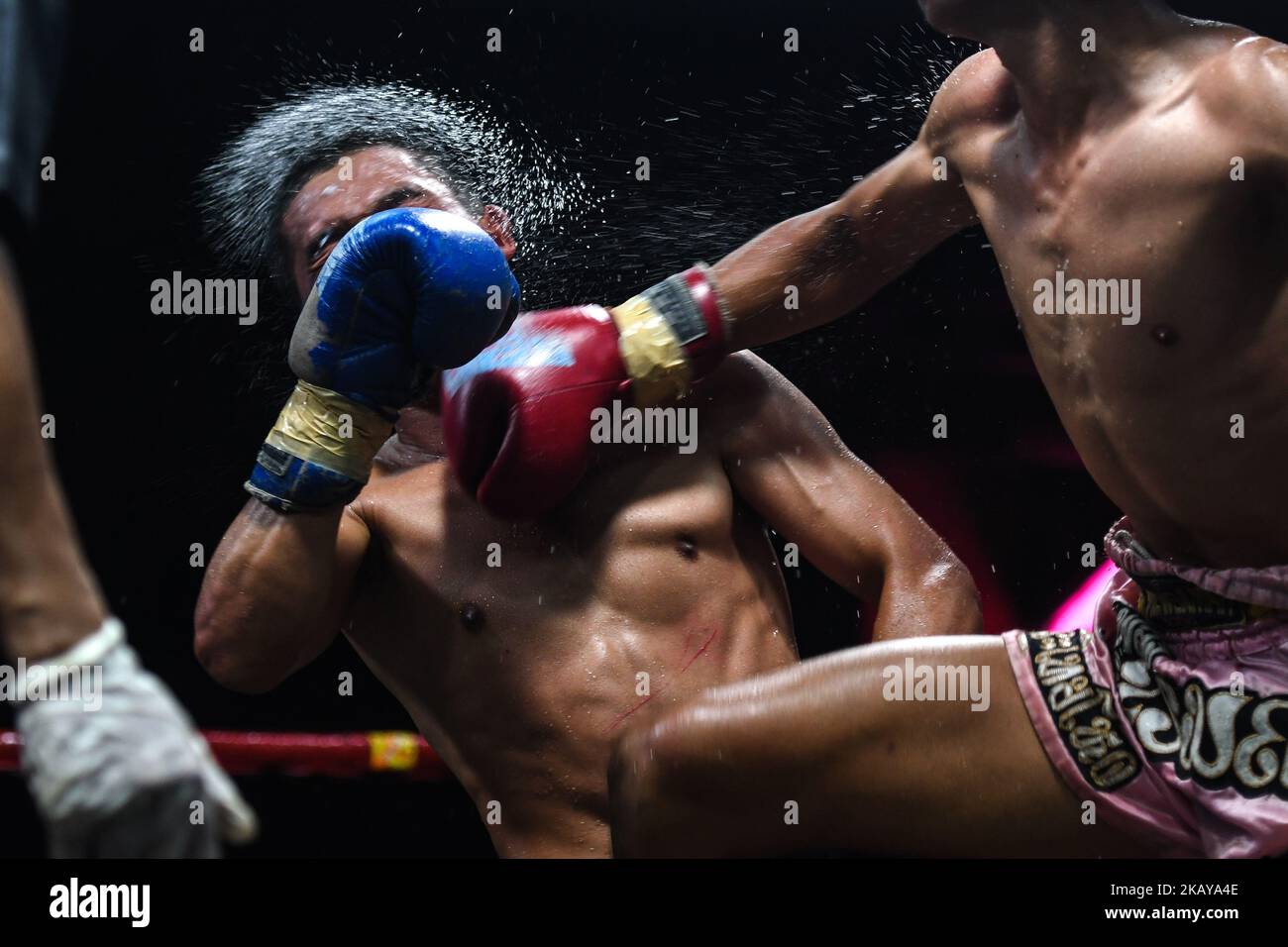 Plerngarom (Red) punches Pongsin (Blue), a Thai boxing combat in 54kg category, during Muaythai Monday Evening International Thai Boxing Gala in Thaphae Stadium in Chiang Mai. On Monday, June 11, 2018, Chiang Mai, Chiang Mai Province, Thailand. (Photo by Artur Widak/NurPhoto)  Stock Photo
