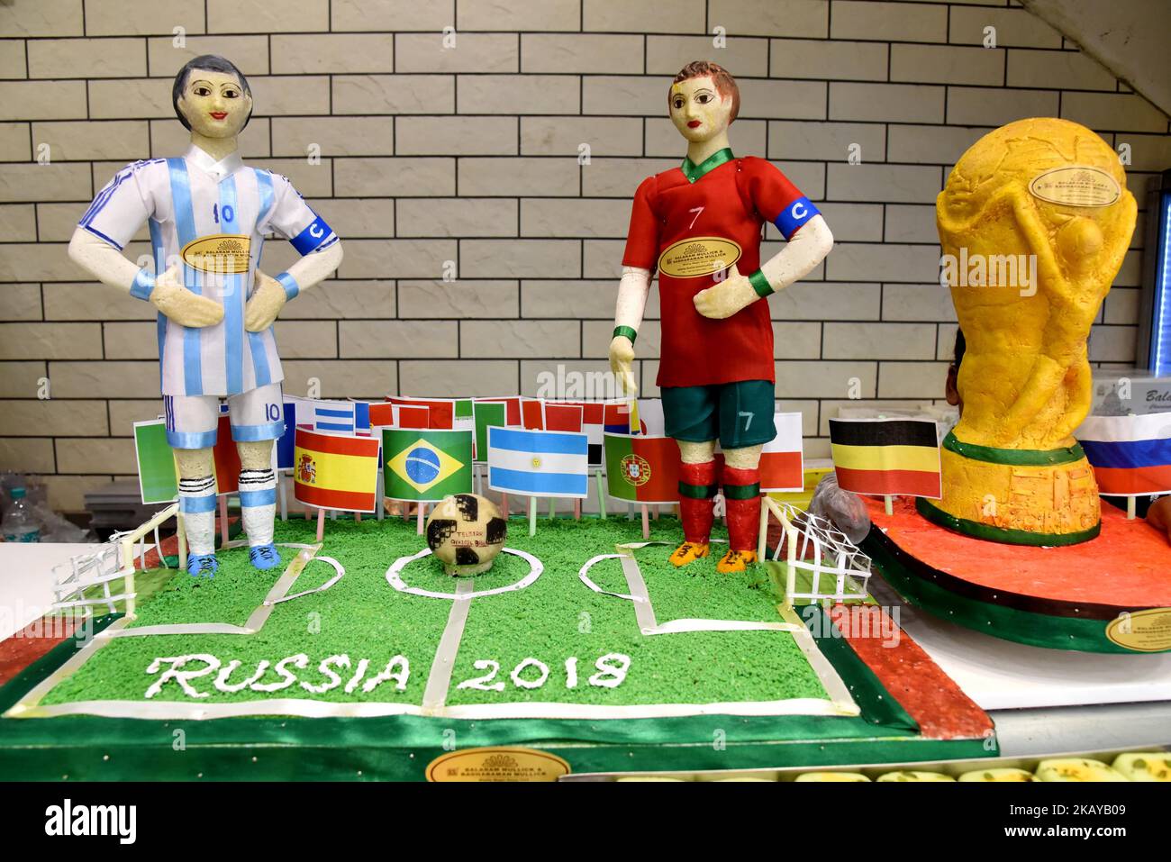 A Sweet shop arranges the display of the FIFA world cup trophy model ahead of the upcoming FIFA Russia 2018 World Cup, in Kolkata on June 13, 2018. (Photo by Debajyoti Chakraborty/NurPhoto) Stock Photo