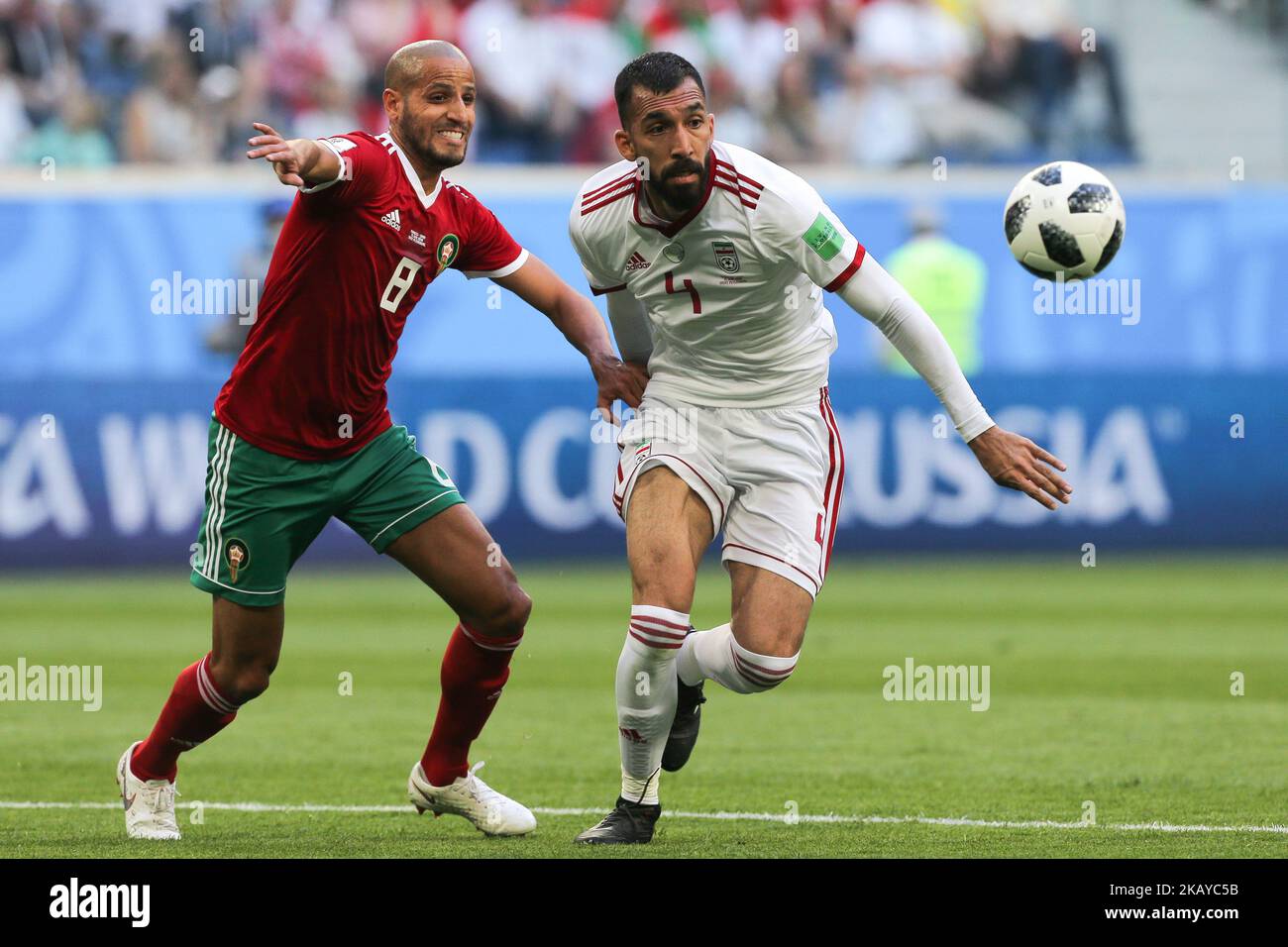 Karim El Ahmadi (L) of the Morocco national football team and Roozbeh Cheshmi of the Iran national football team vie for the ball during the 2018 FIFA World Cup match, first stage - Group B between Morocco and Iran at Saint Petersburg Stadium on June 15, 2018 in St. Petersburg, Russia. (Photo by Igor Russak/NurPhoto) Stock Photo