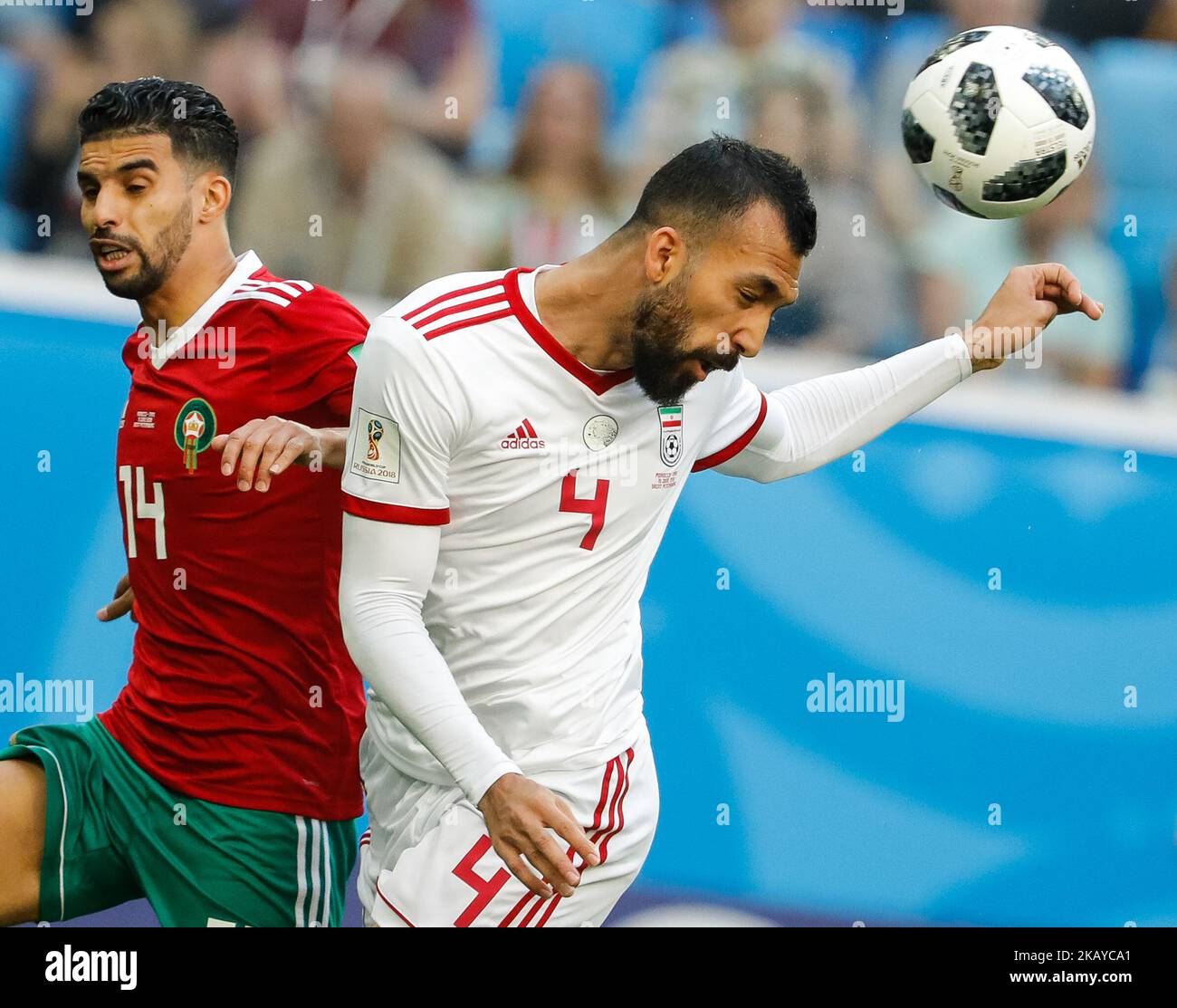 Mbark Boussoufa (L) of Morocco national team and Roozbeh Cheshmi of IR Iran national team vie for the ball during the 2018 FIFA World Cup Russia Group B match between Morocco and IR Iran on June 15, 2018 at Saint Petersburg Stadium in Saint Petersburg, Russia. (Photo by Mike Kireev/NurPhoto) Stock Photo